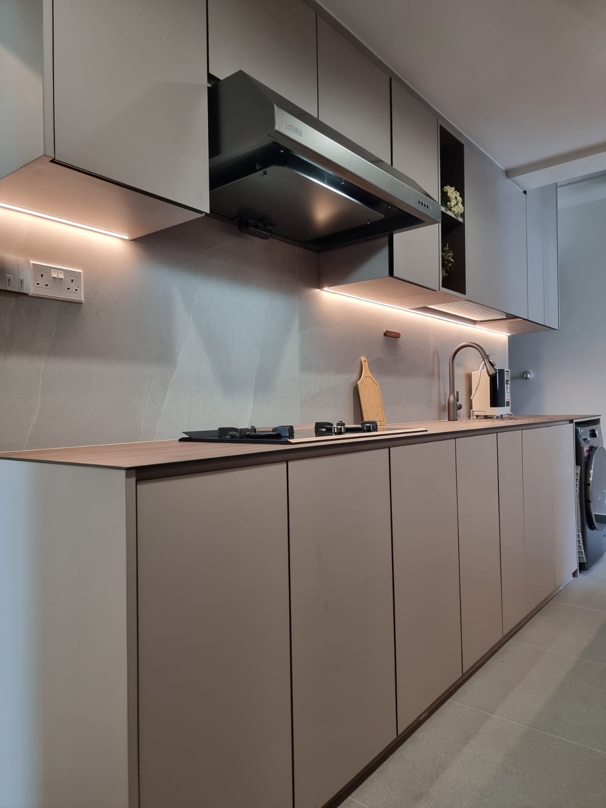 the heart of our home--Our kitchen! - Modern kitchen with sleek cabinets, stainless steel range hood, under-cabinet lighting