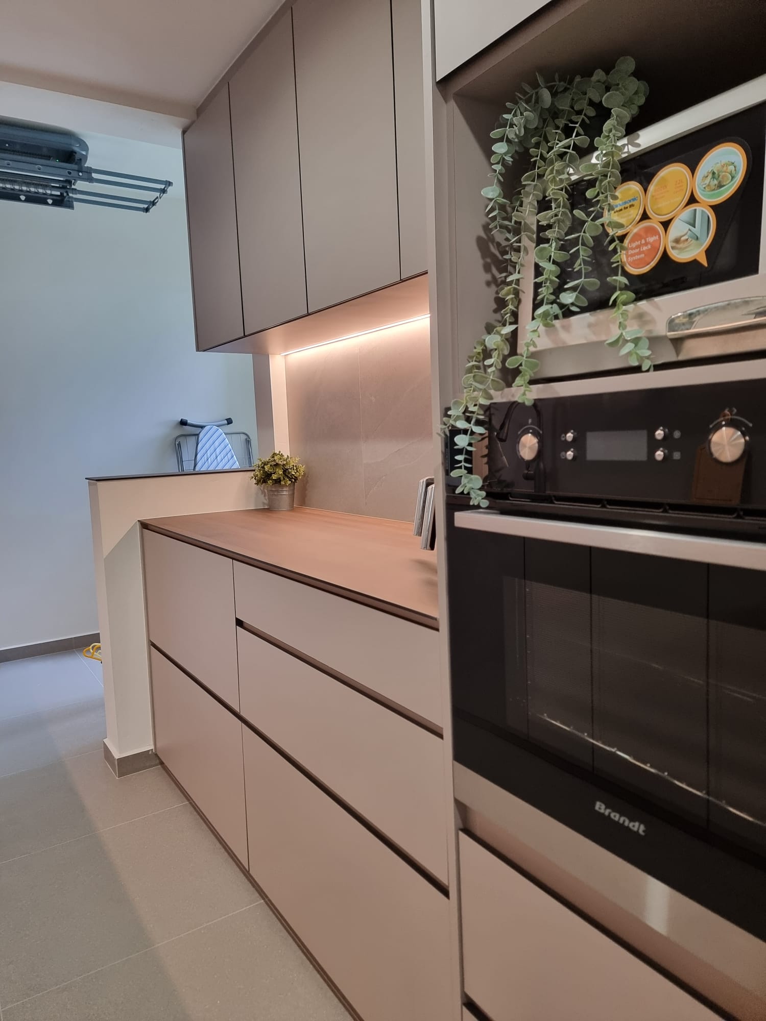 the heart of our home--Our kitchen! - Modern kitchen with sleek cabinets, light beige and gray tones, built-in appliances
