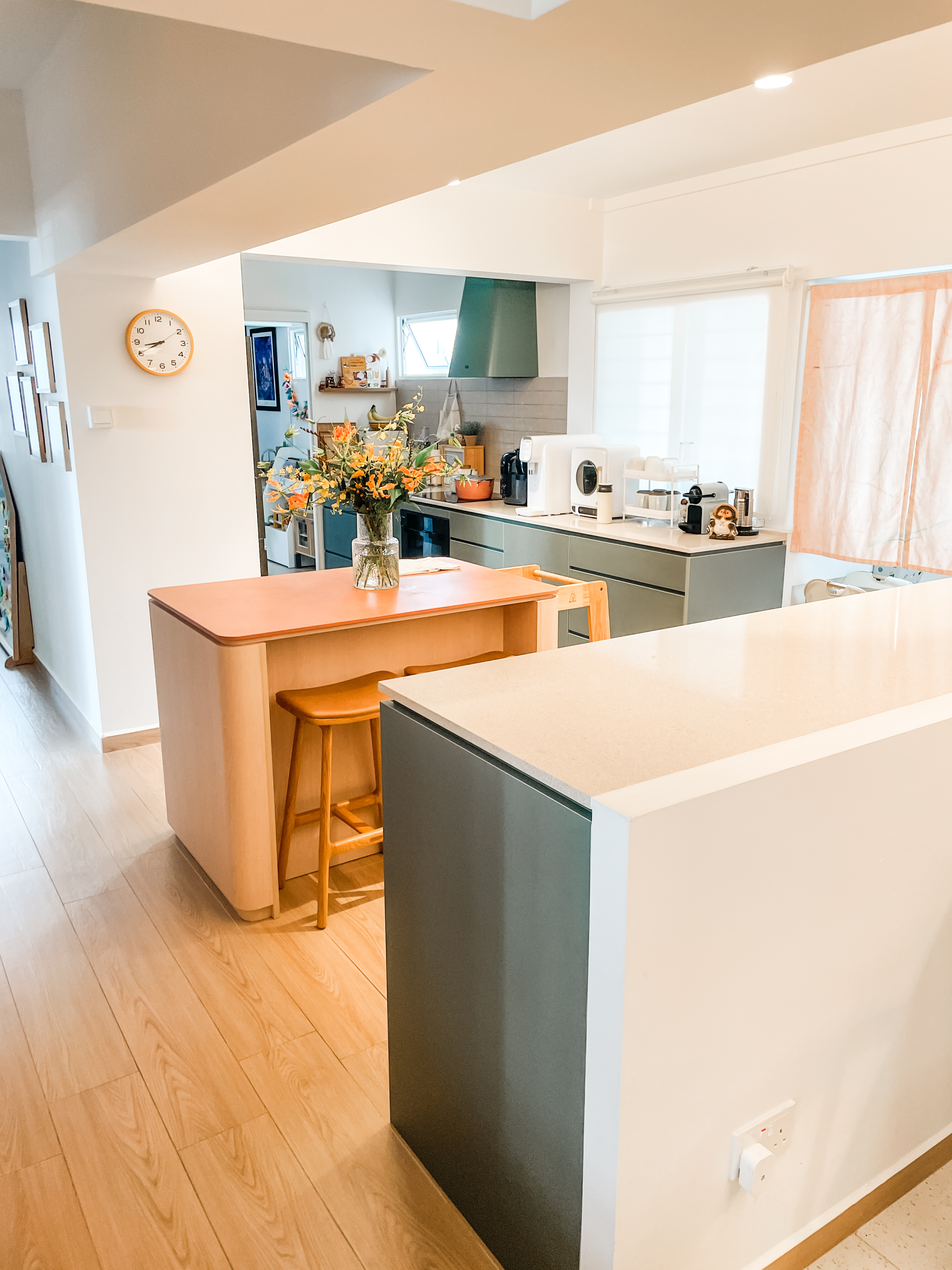 An Open-Plan Kitchen With A Secret "Mama Shop"  - Modern kitchen with wooden floor, light beige countertops, white cabinets