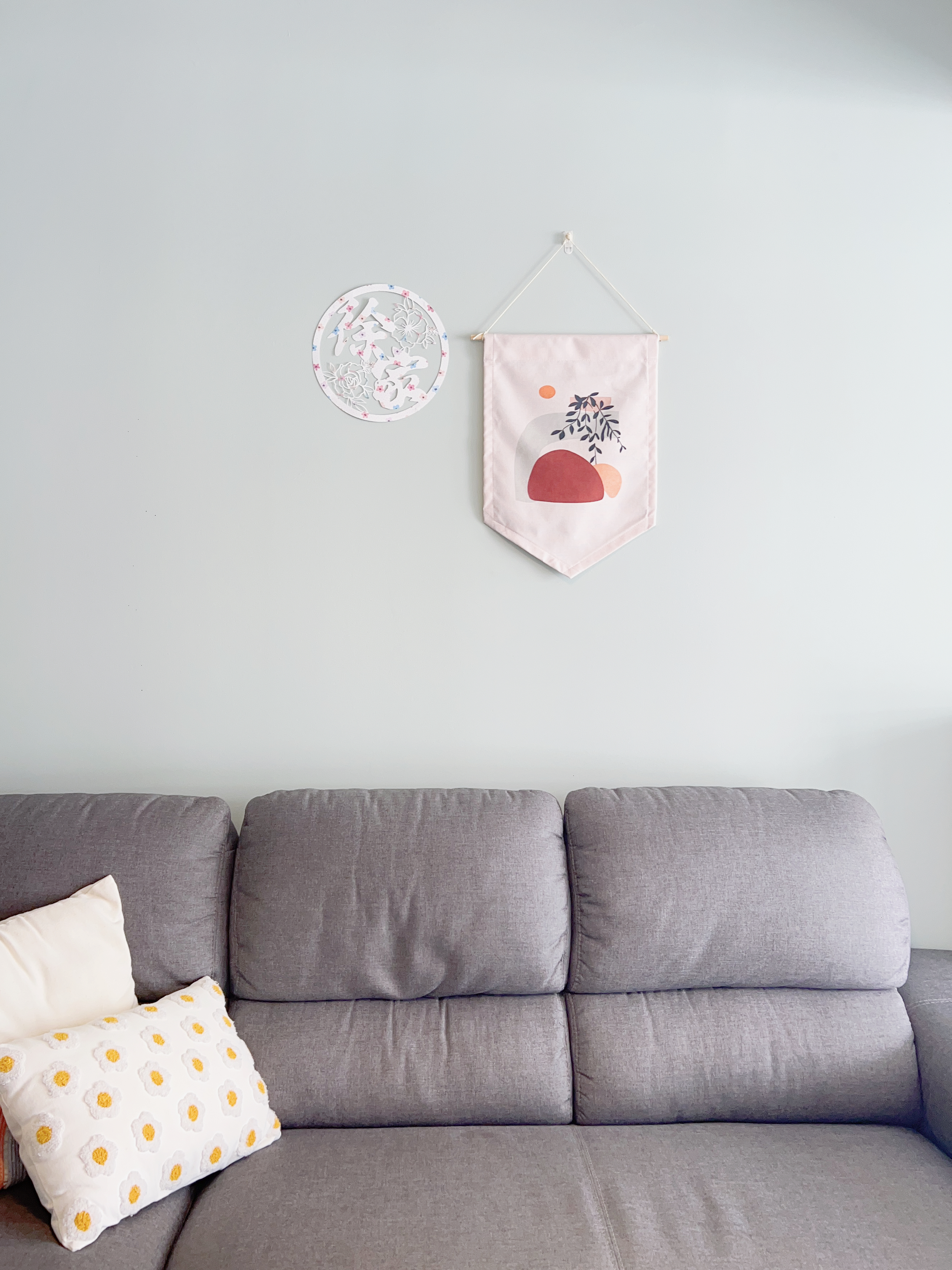 Turn Your Home into a Green Paradise.. Without Actual Plants! - hangings, cushions, gray sofa, modern decor, minimalist