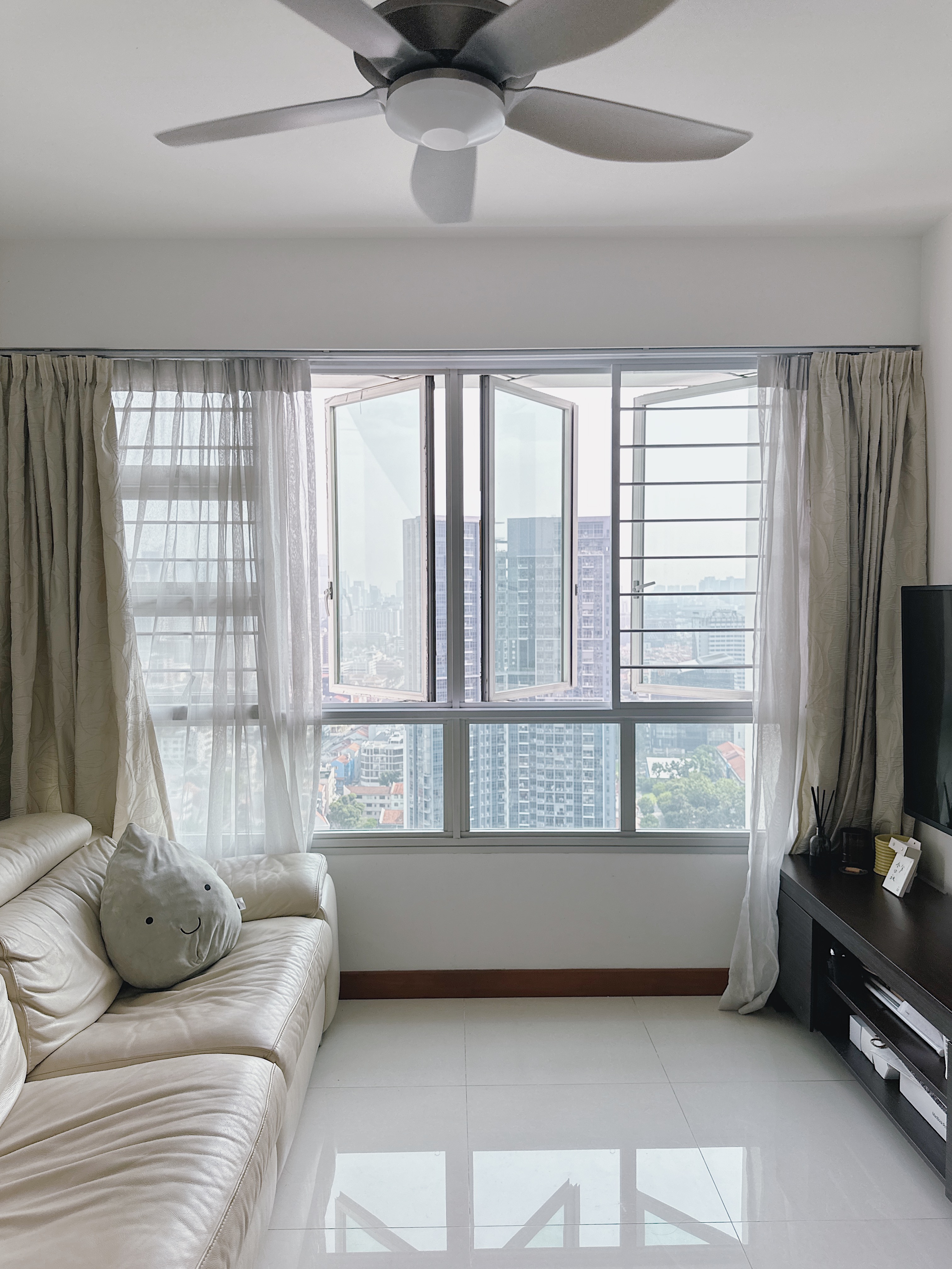 Love & Light: What Brings You Joy? - Modern living room, spacious room, large windows, city view, beige sofa, decorative