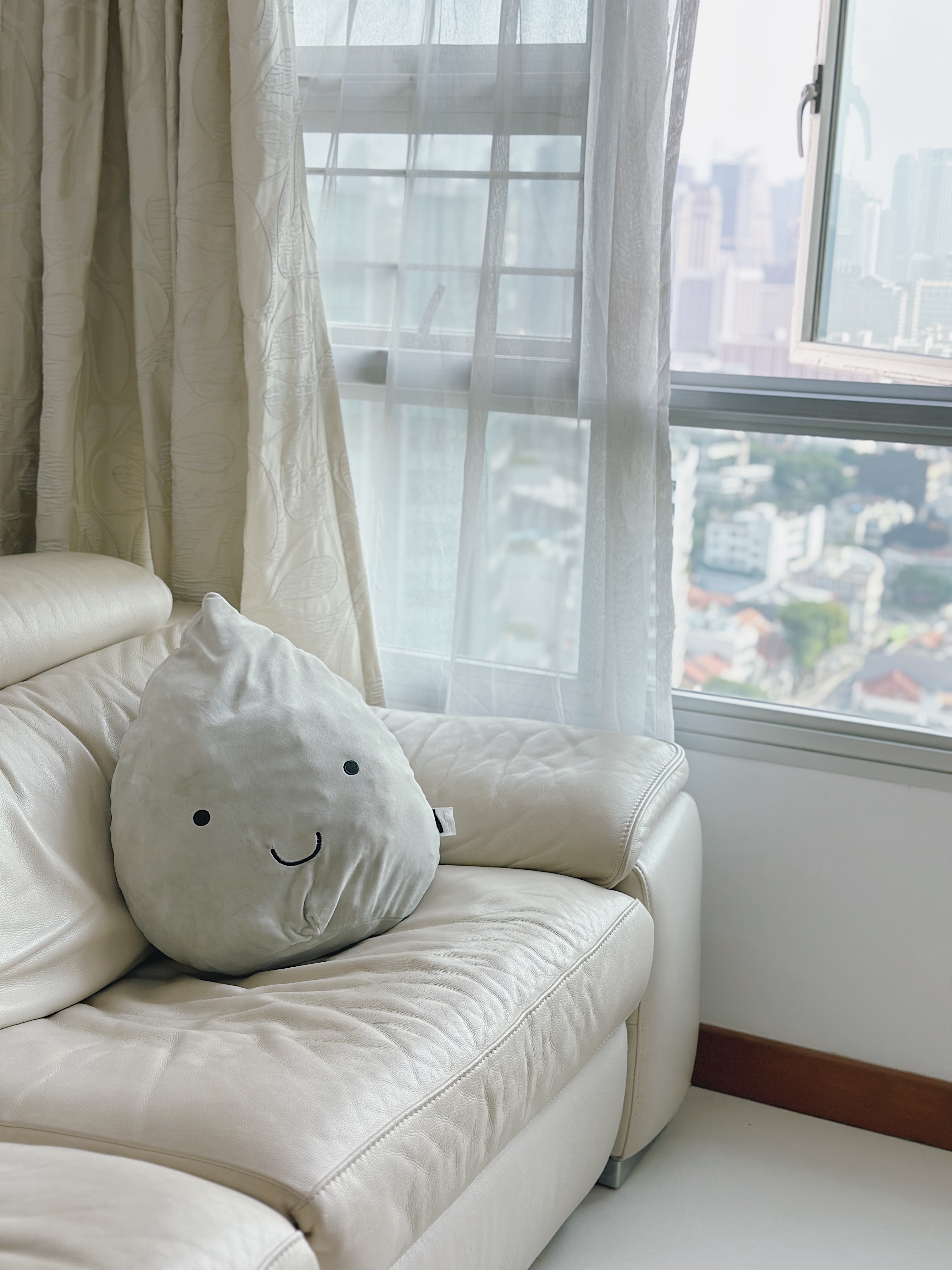 Love & Light: What Brings You Joy? - Leather sofa, beige curtains, cityscape view, soft lighting, cozy atmosphere, plush