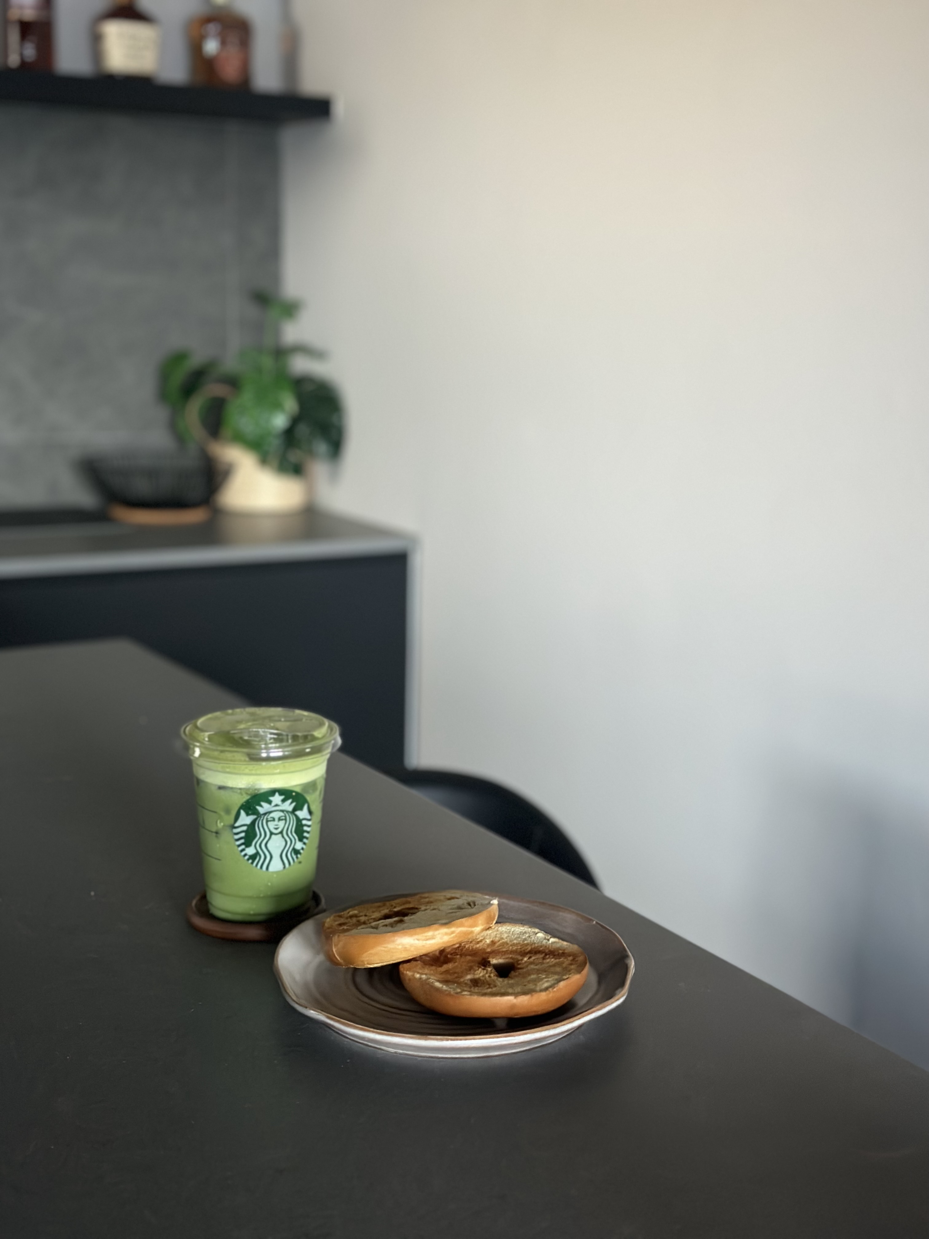 Where conversations, food, games and wine flow - green smoothie, Starbucks, cup, sliced bread, plate, wooden spoon, modern