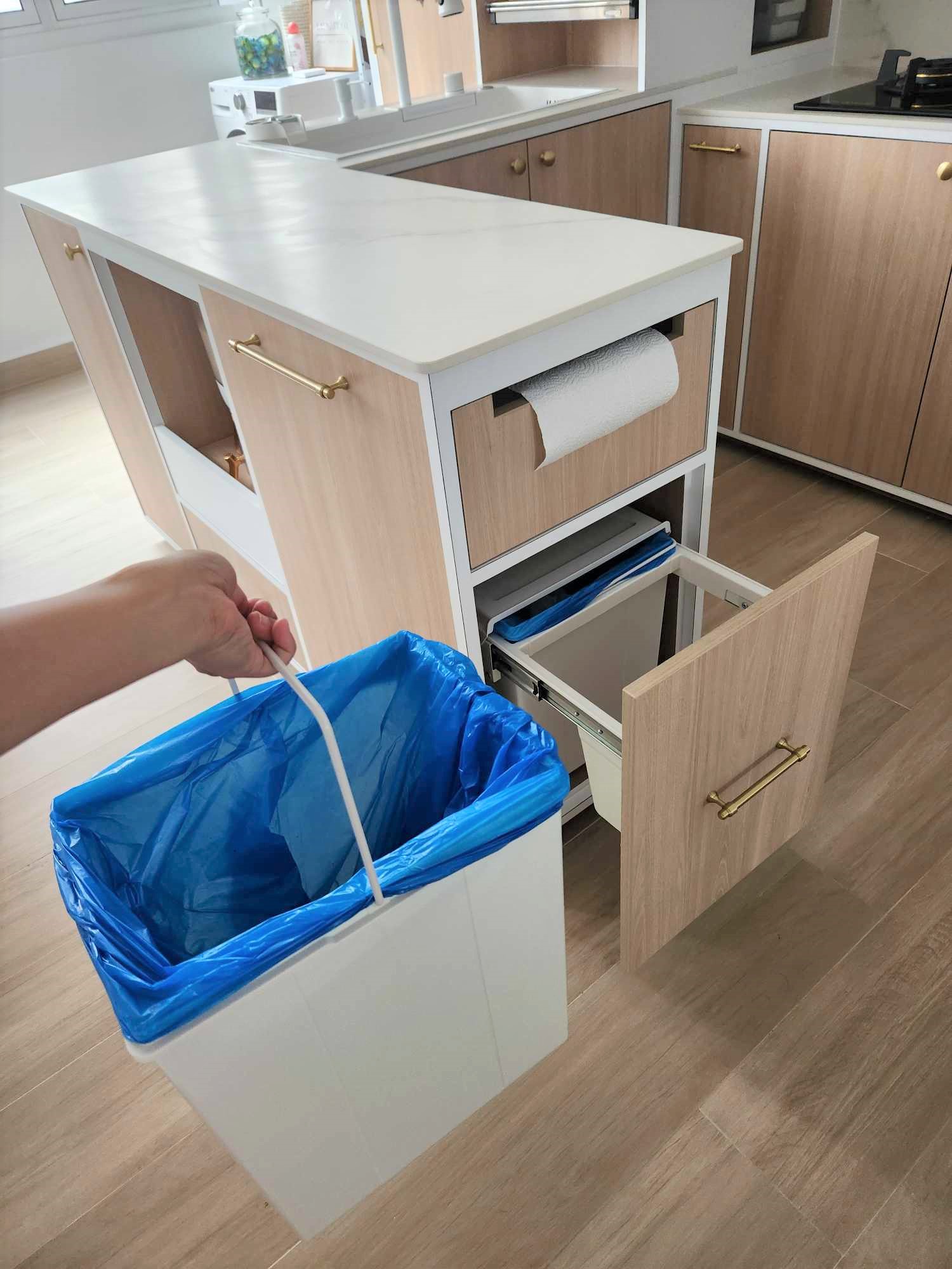 Spacious U-shaped kitchen  - Kitchen island, wooden cabinets, white countertops, blue trash bin, open drawer, kitchen