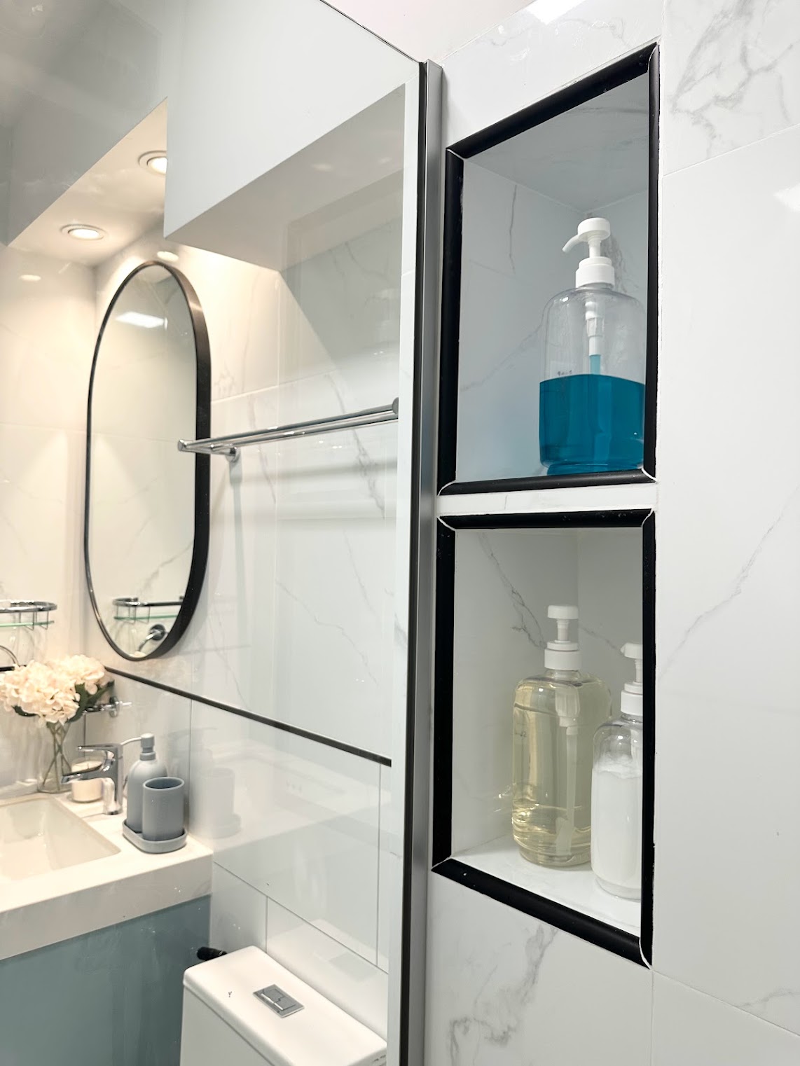 Transforming the Bathroom on a Budget - White marble tiles, modern bathroom, sleek design, minimalist decor, floating shelf