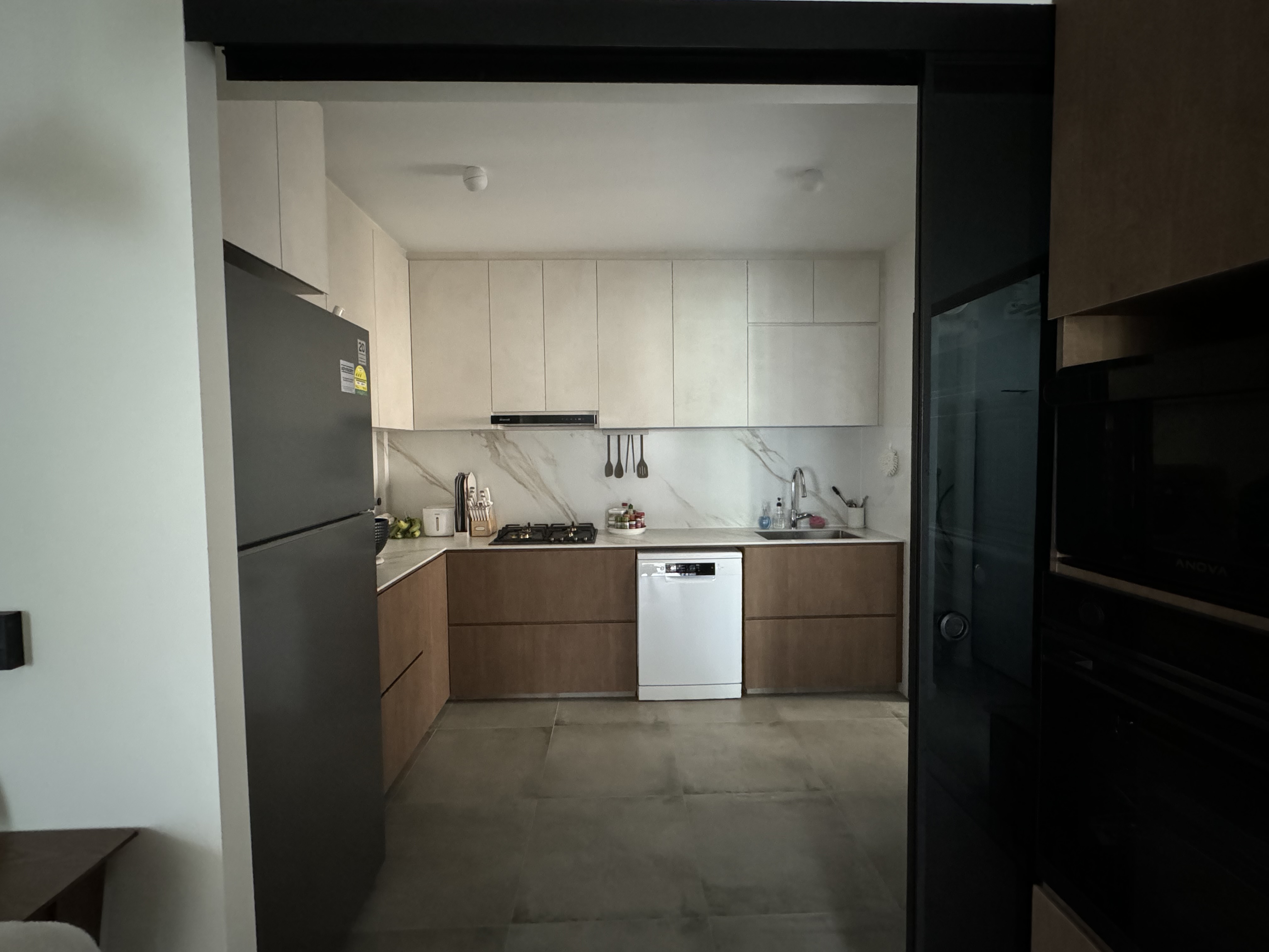 Our Wabi-Sabi Kitchen 🪨 - Modern kitchen with sleek design, white cabinets and marble backsplash, stainless steel