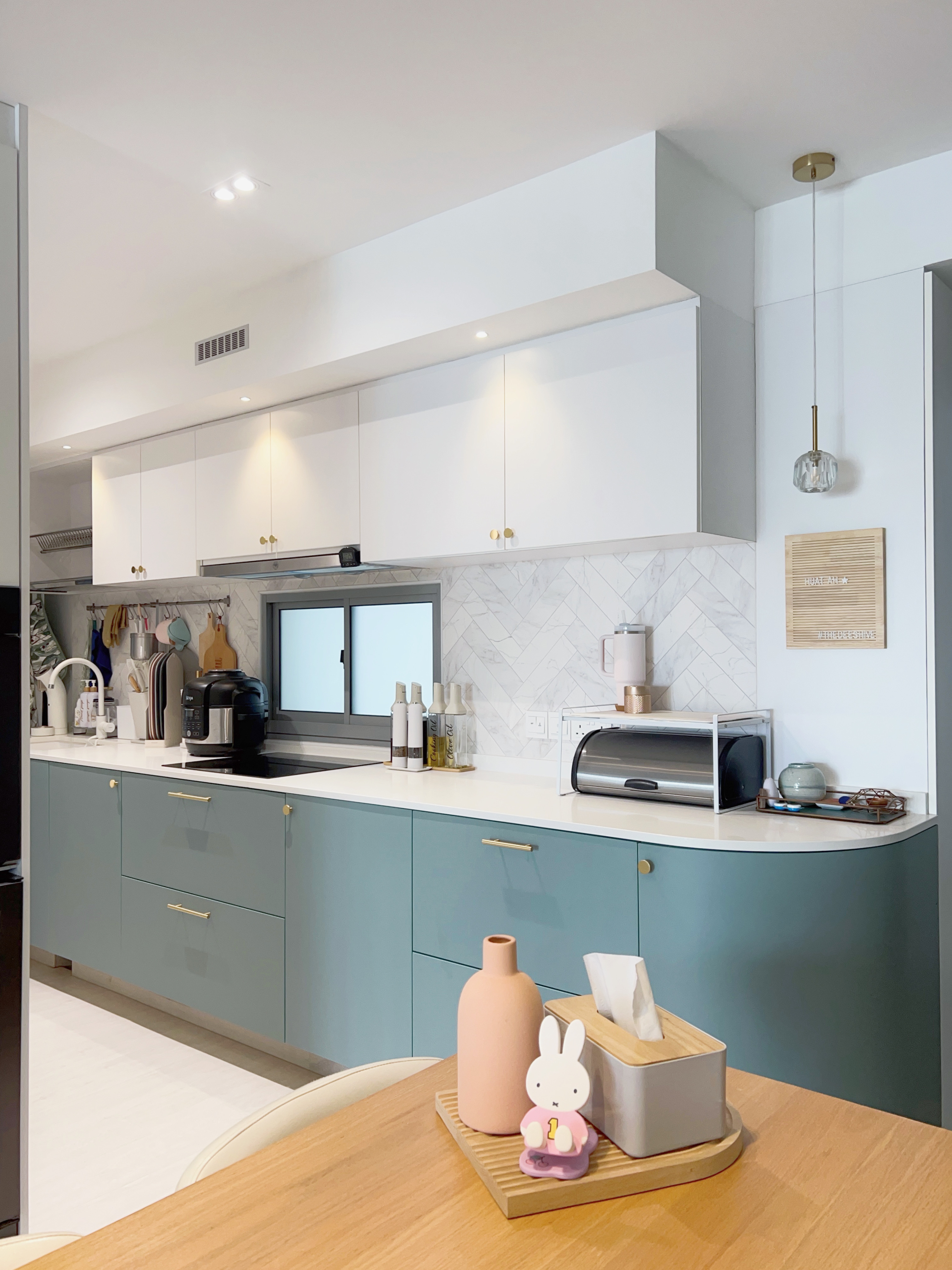 Tips on Organising an Open Concept Kitchen - Modern kitchen with white cabinets and light blue countertops, sleek appliances