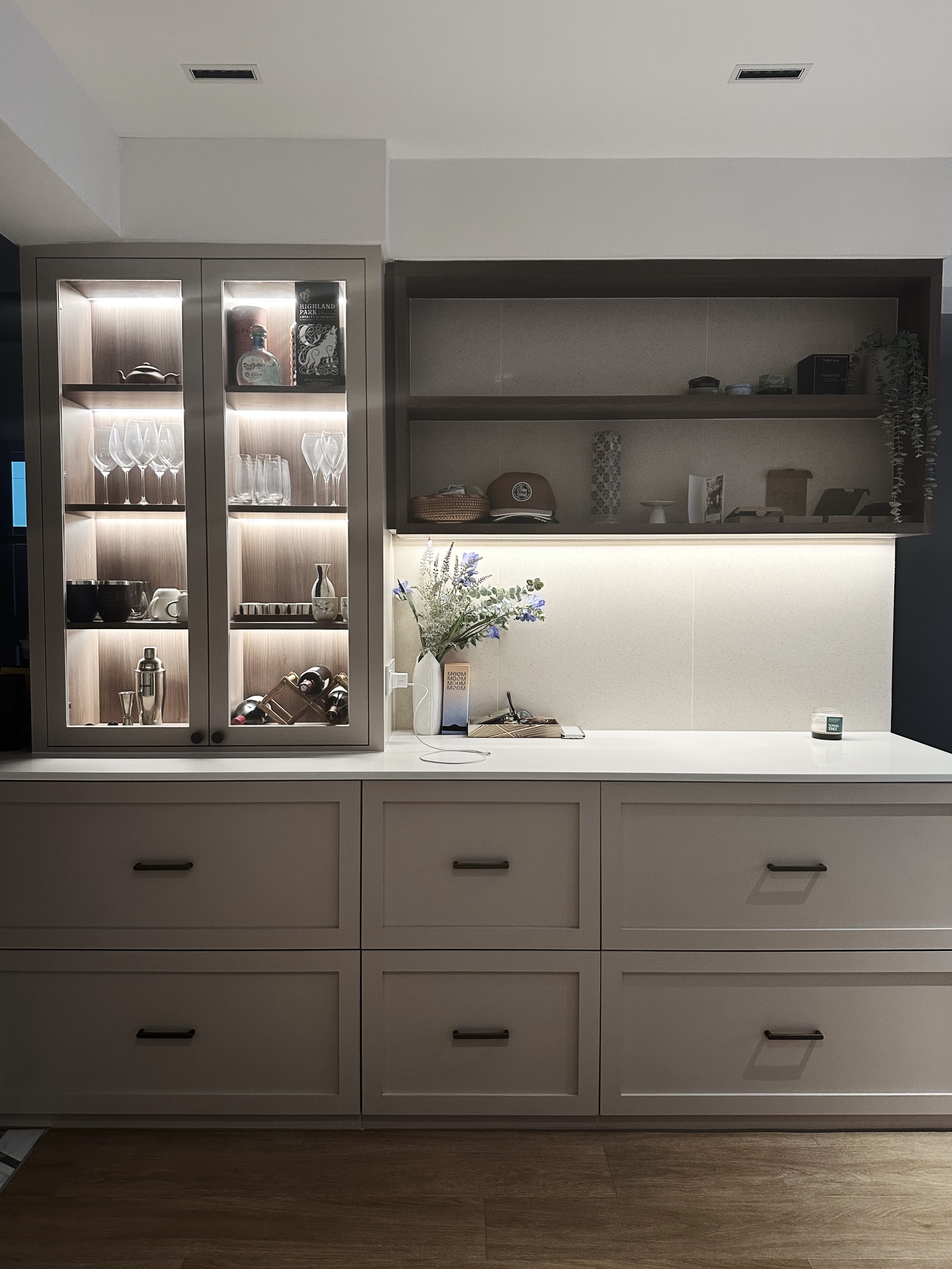 Step inside our kitchen 😋 - Shelf with glassware, wine bottles, and decorative items, illuminated cabinet, minimalist