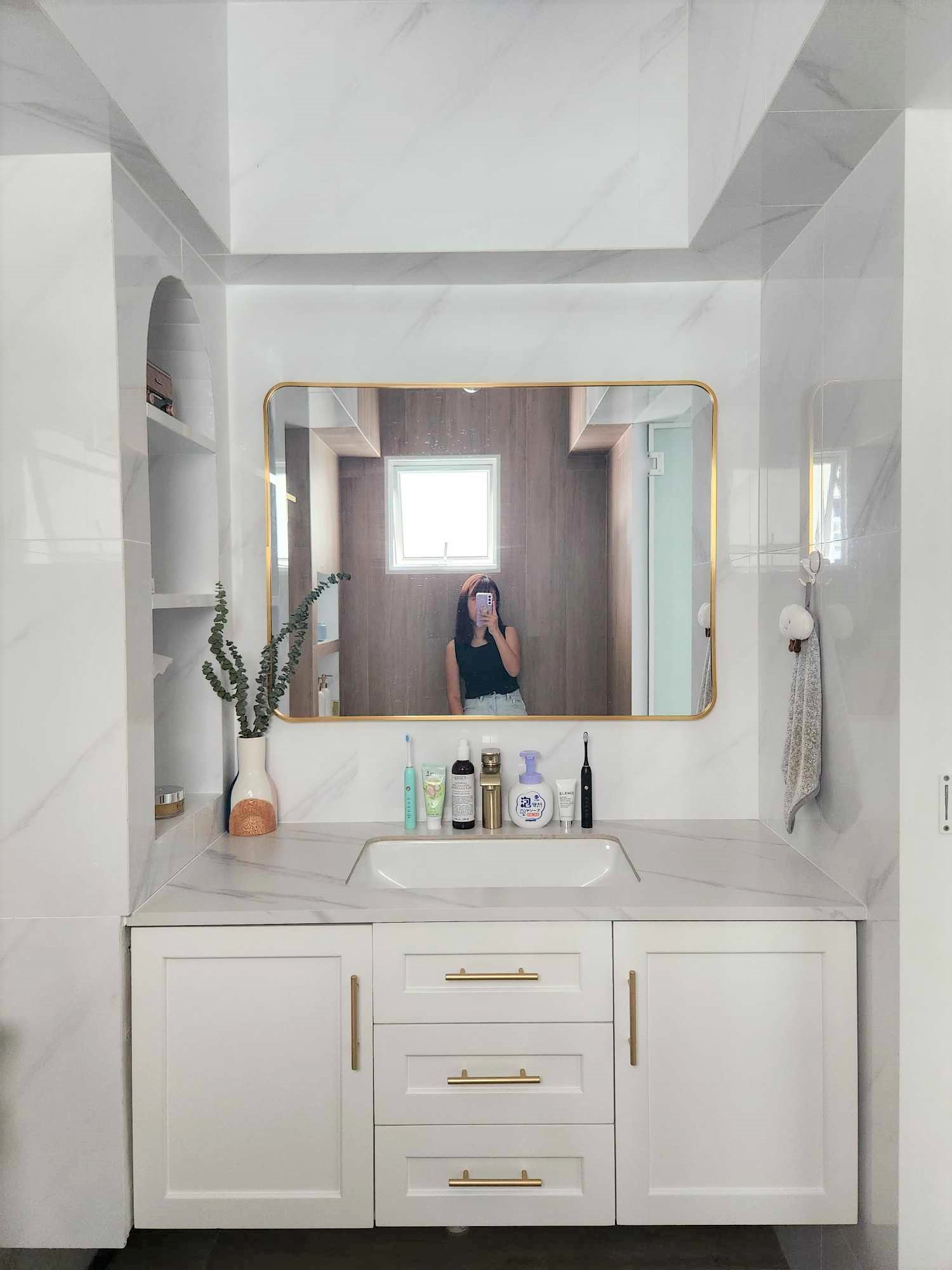 Hotel Vibes Bathroom 😍 - White marble bathroom vanity, gold-framed mirror, modern design, minimalist decor, white cabinets