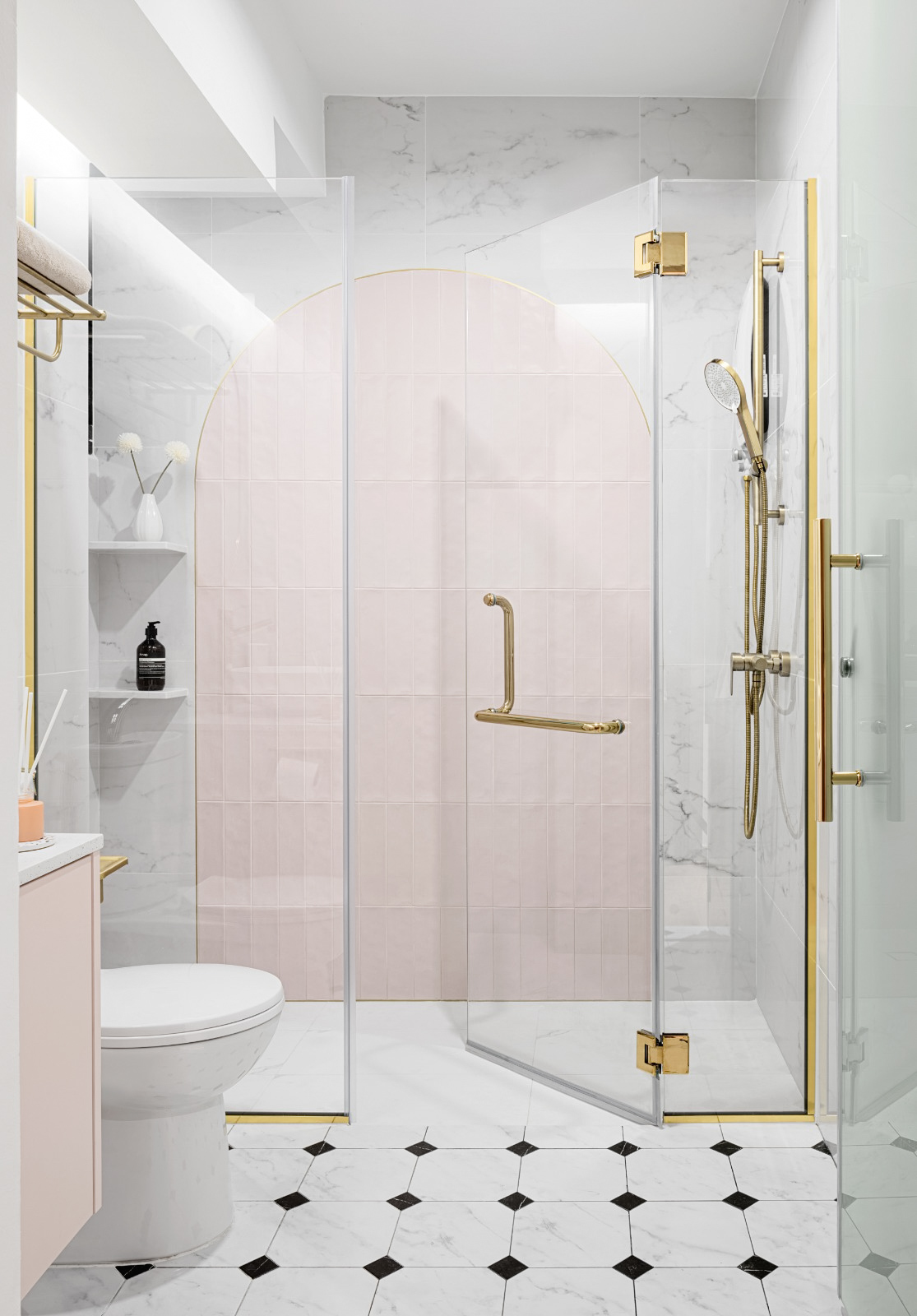 The essential heart of the home: The bathroom ✨ - Modern bathroom with glass shower enclosure, pink-tiled shower wall, gold