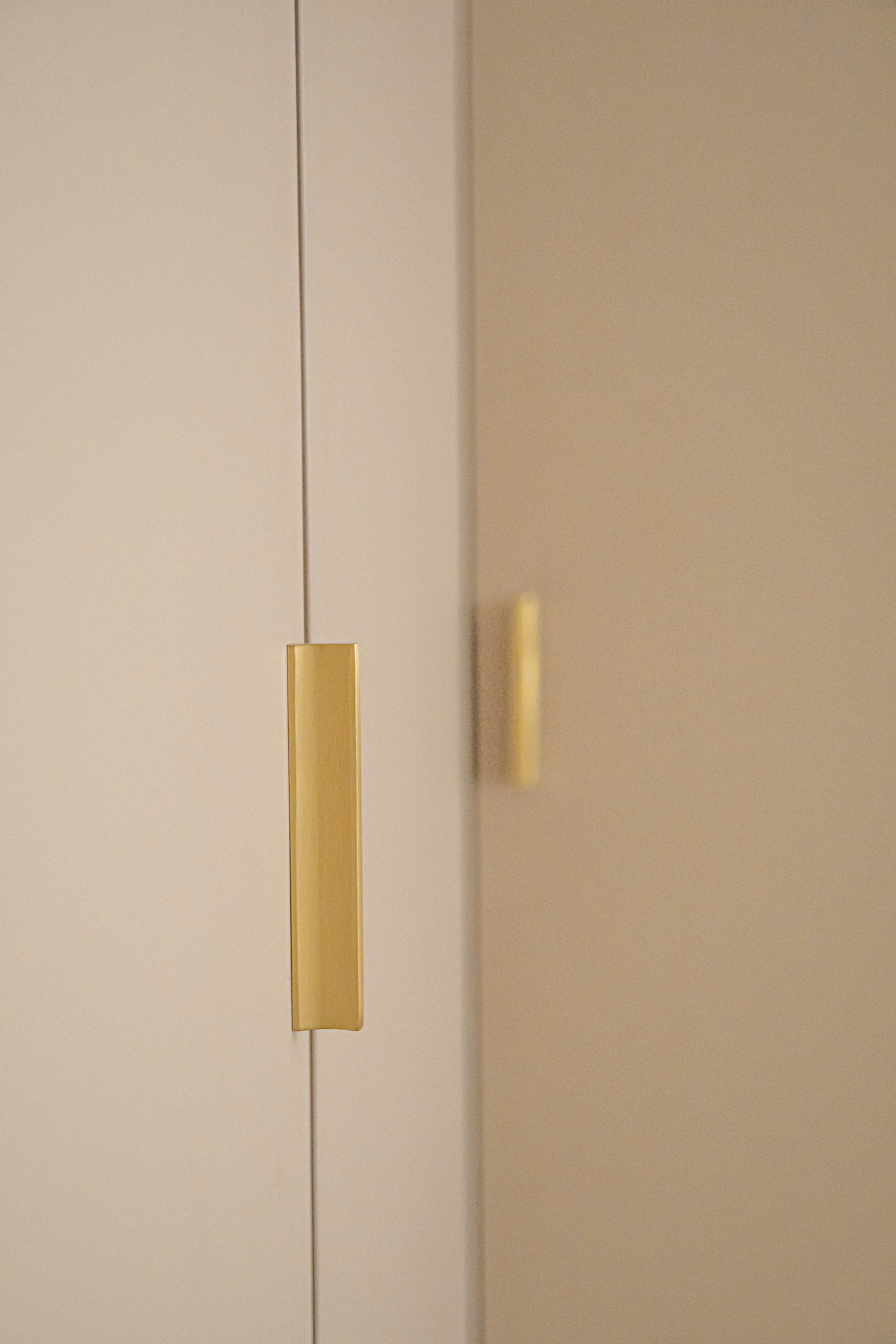 Tips to Create A Feminine Boho Bedroom - Gold door handle, minimalist design, modern aesthetic, sleek finish, vertical