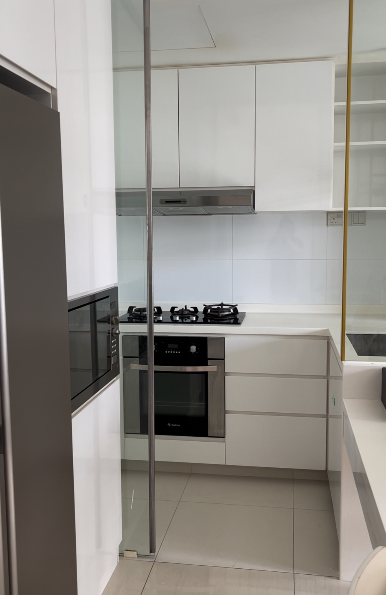Our Kitchen: Before & After  - Modern kitchen with sleek white cabinets and stainless steel appliances, including a built-in