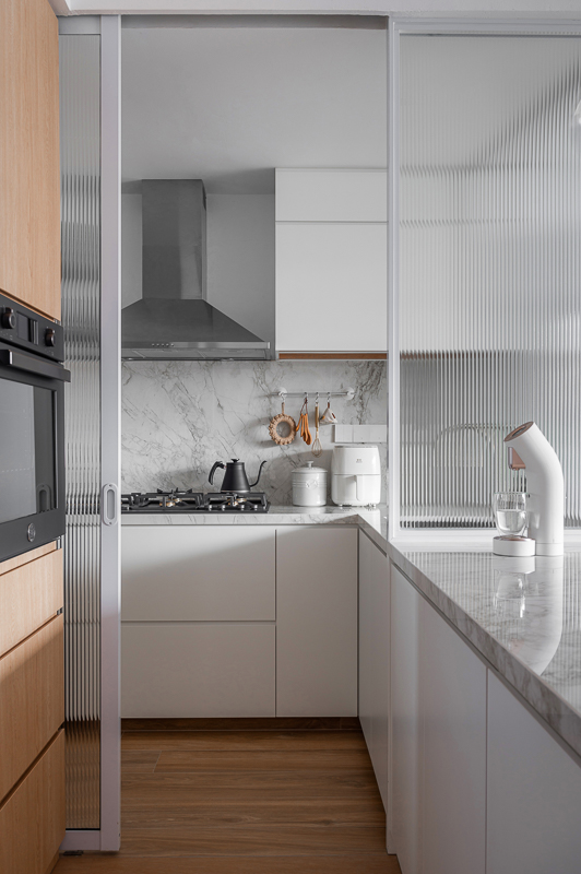 Our Kitchen: Before & After  - White kitchen with marble backsplash, stainless steel range hood, wooden cabinets, black