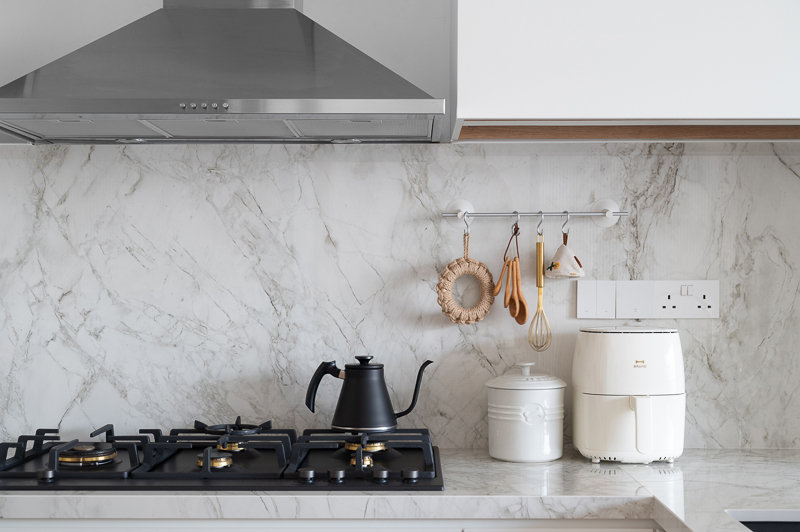 Our Kitchen: Before & After  - Stainless steel range hood, marble backsplash, black kettle, white countertop, modern kitchen