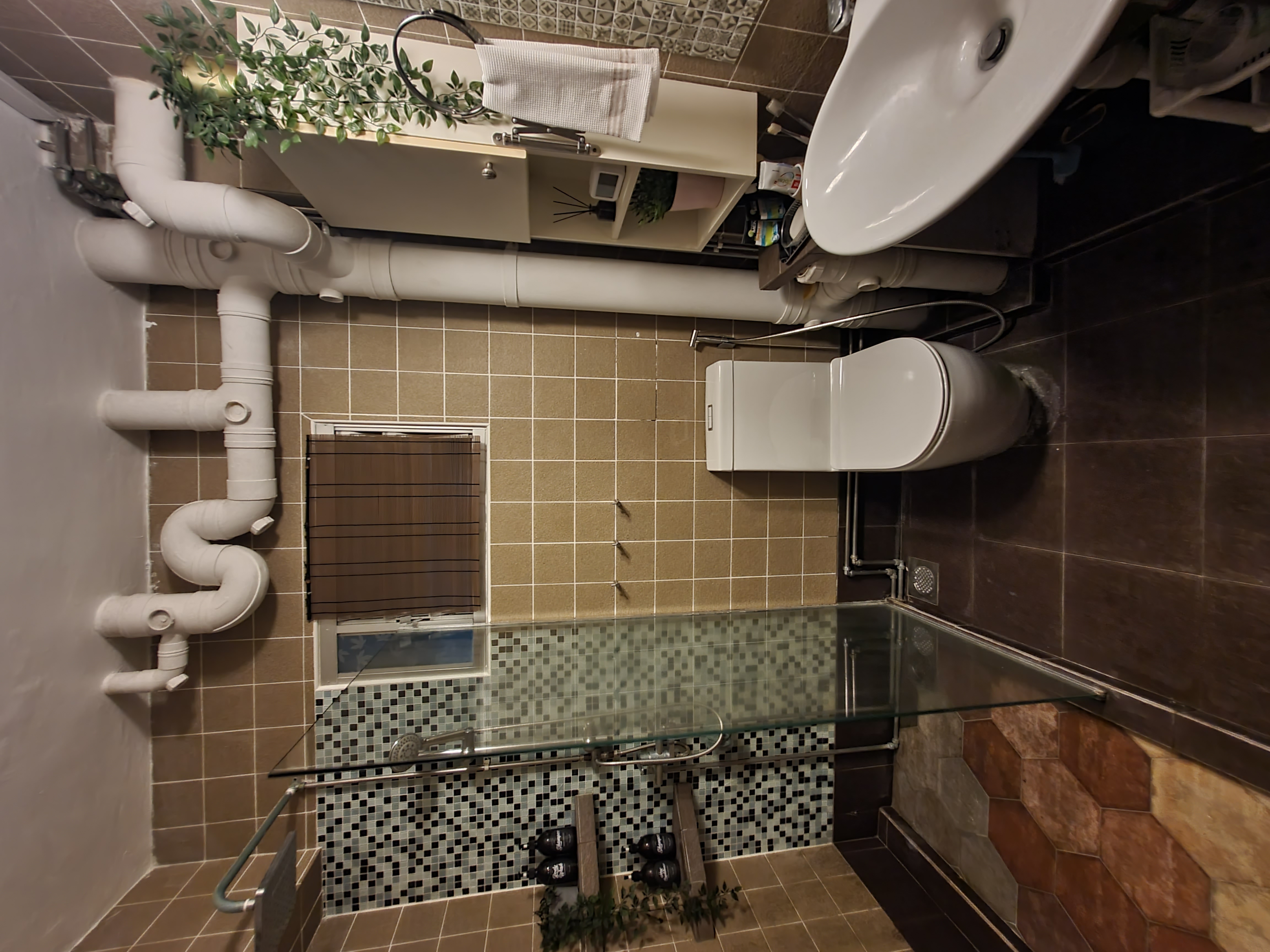 Unrenovated Bathroom - Bathroom, tiled walls, brown and beige tiles, white toilet, white sink, white toilet paper holder