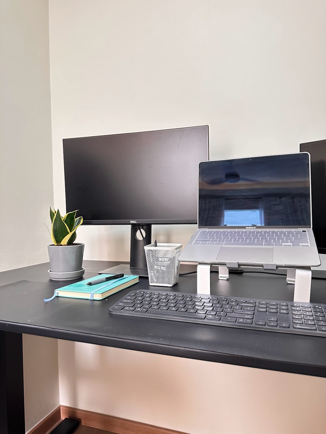Home Office Within The Bedroom - desk setup, dual monitors, black desktop, silver laptop, keyboard, notebook, pen, plant