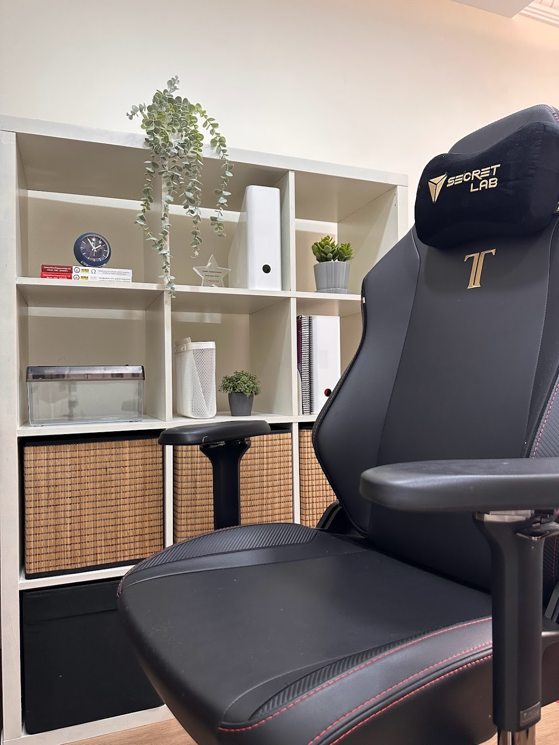 Home Office Within The Bedroom - black gaming chair, ergonomic design, black leather upholstery, red stitching, modern office