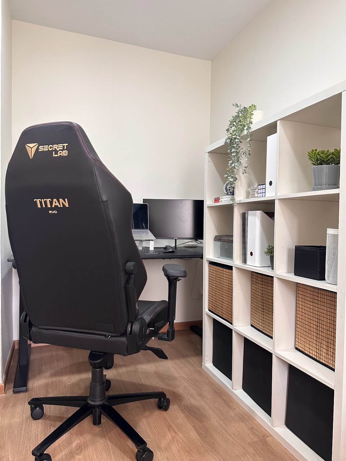 Home Office Within The Bedroom - Sleek black gaming chair with "Secret Lab" and "Titan EVO" branding., Modern home office