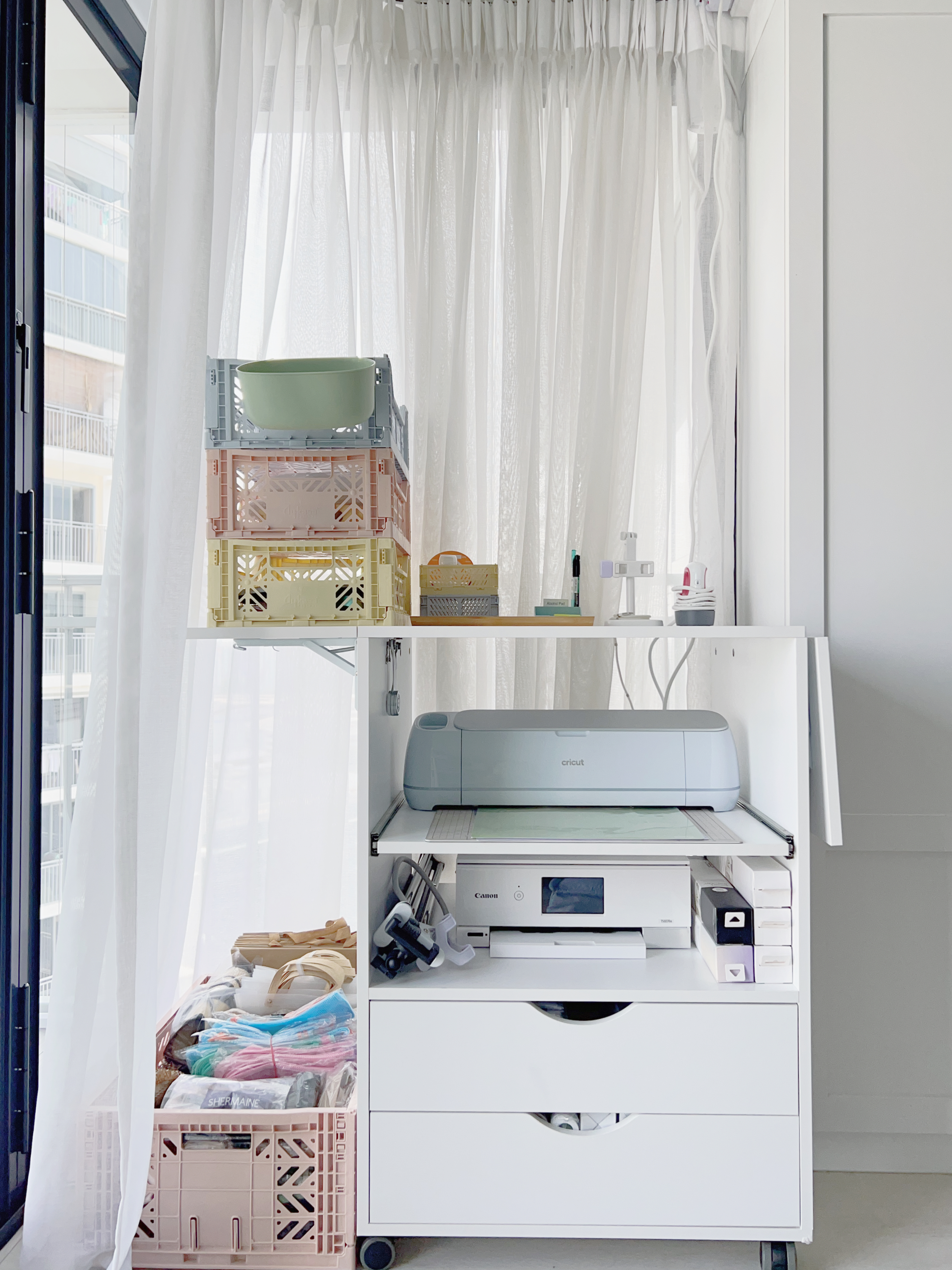 How to Design a Small but Functional Home Workspace - White room with sheer curtains, light blue and pink plastic crates