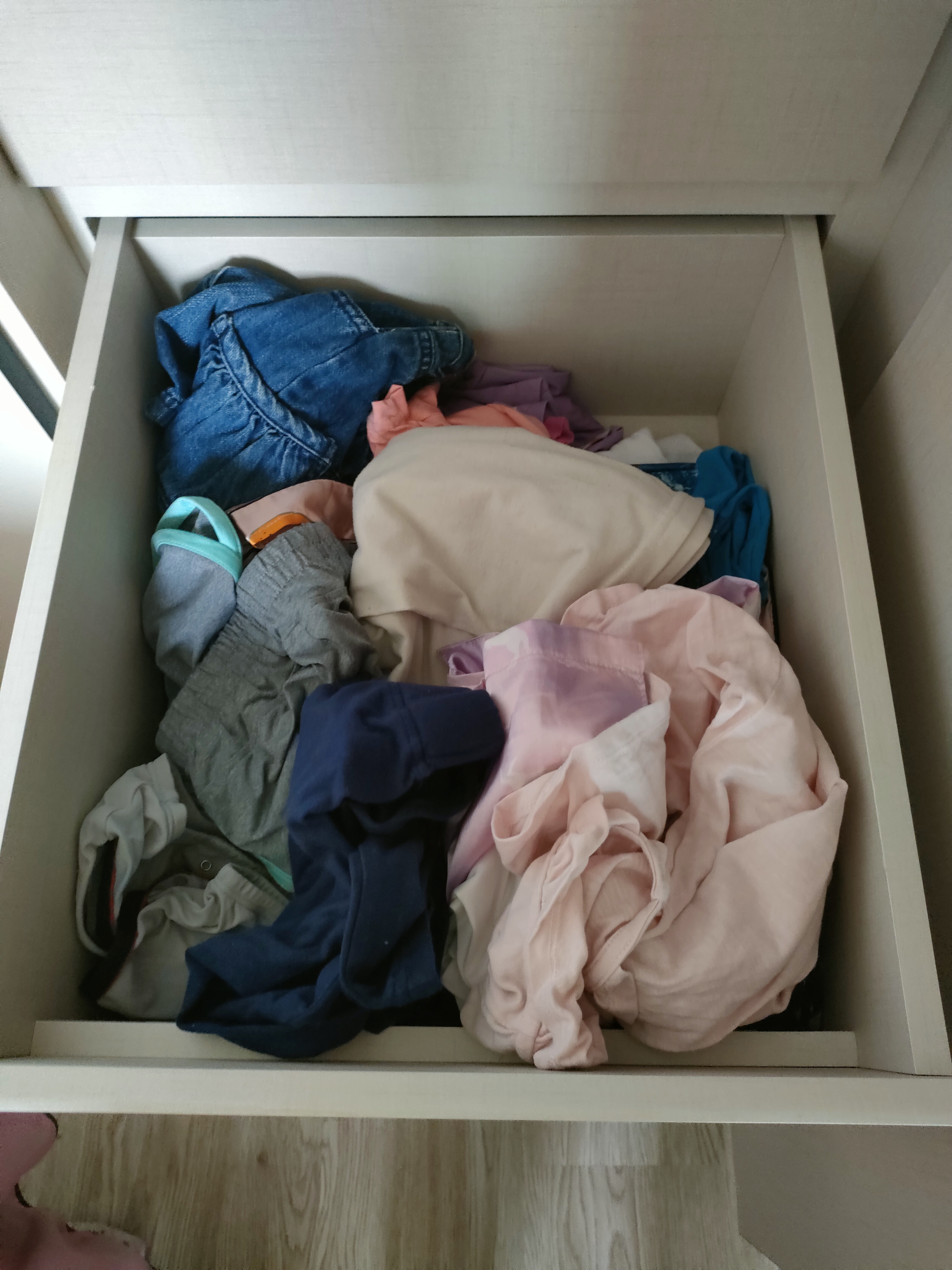 Each kid gets a bedroom!  - Folded clothes, drawer, clutter, disorganized, pile of clothes, jeans, gray shirt, pink shirt