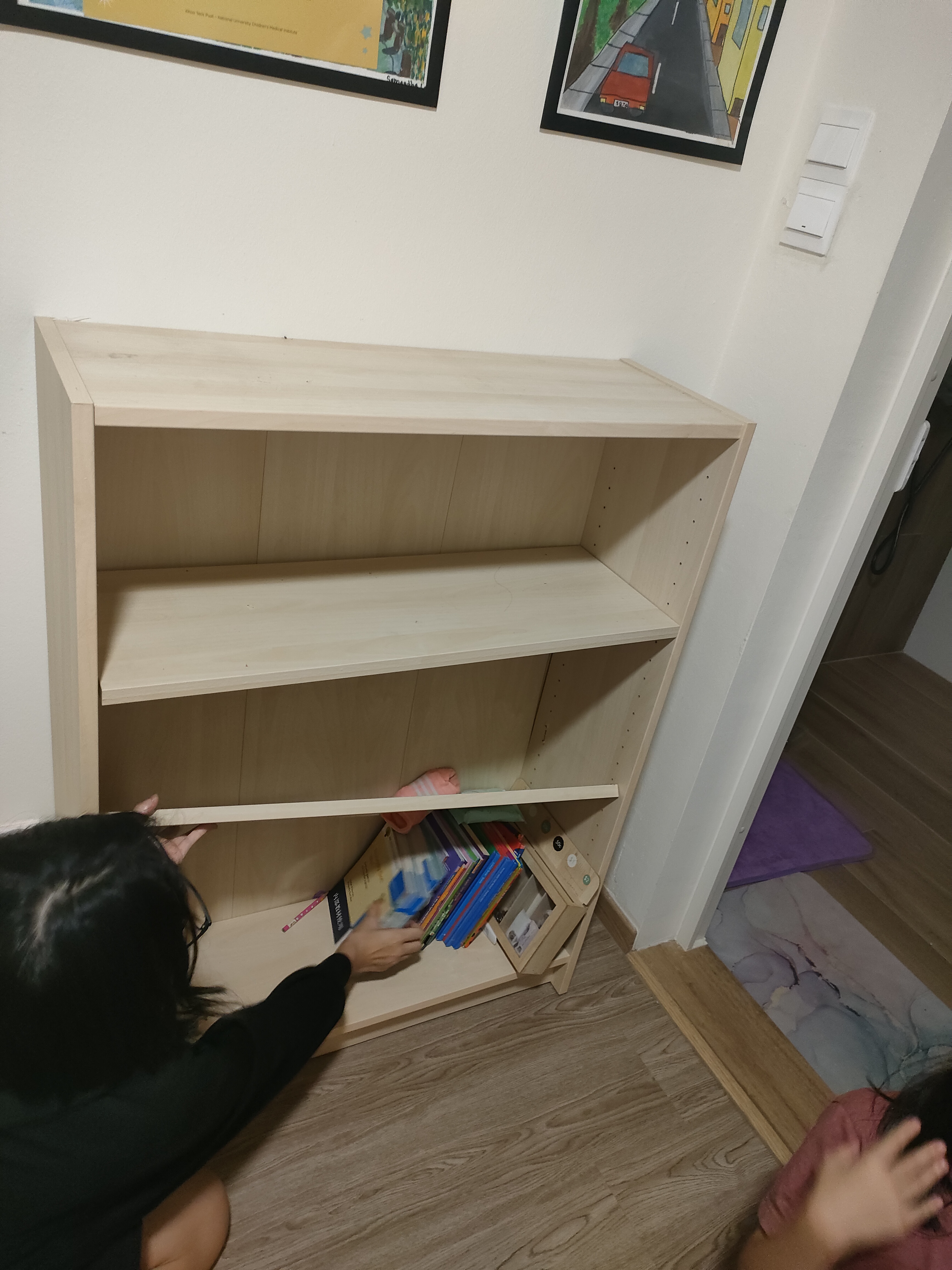 Each kid gets a bedroom!  - Wooden shelf, empty shelves, person searching, books, colorful books, small shelf, wooden
