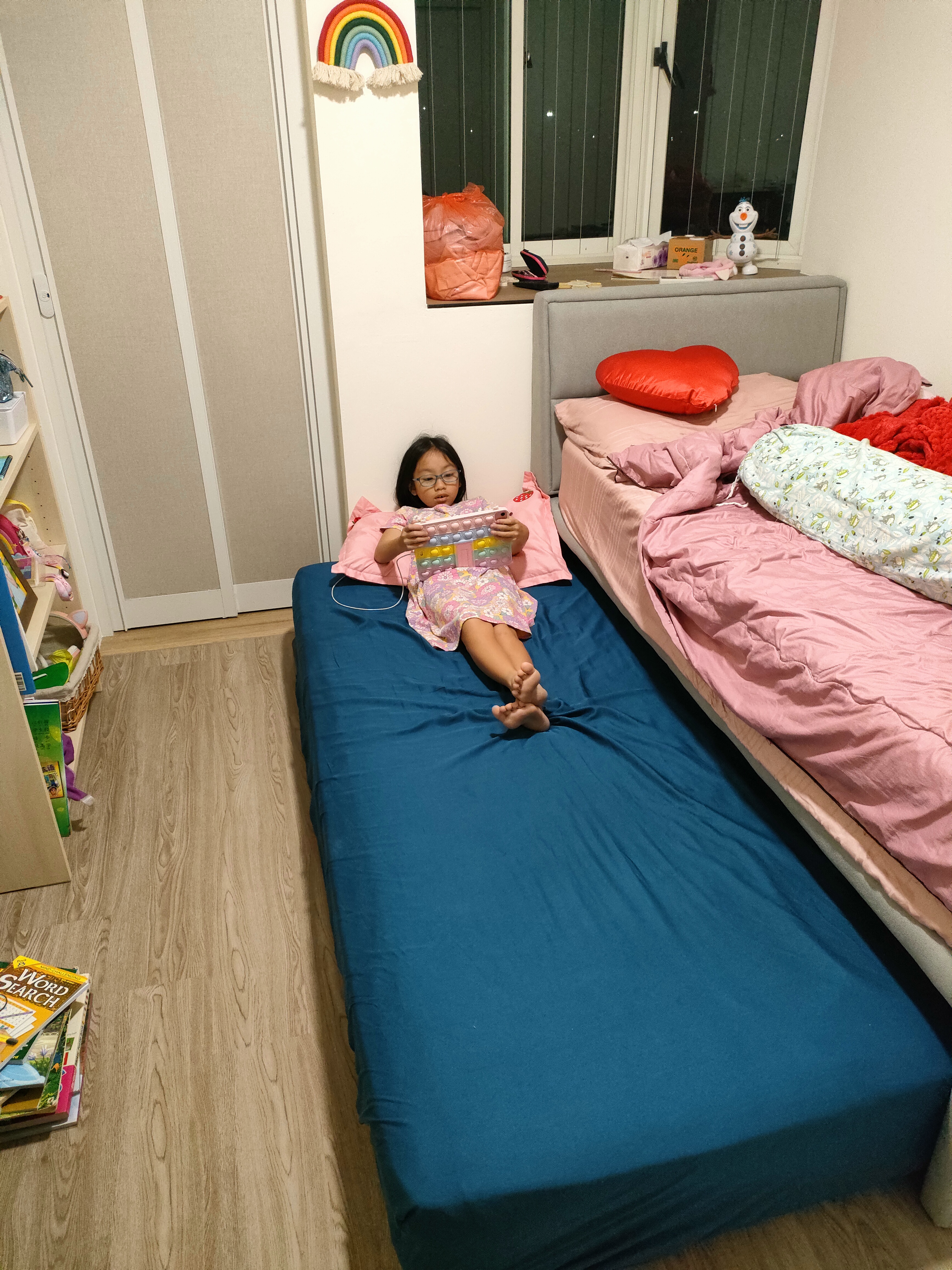 Each kid gets a bedroom!  - Children's bedroom, girl playing, lying on bed, colorful toy, rainbow decoration, orange bag