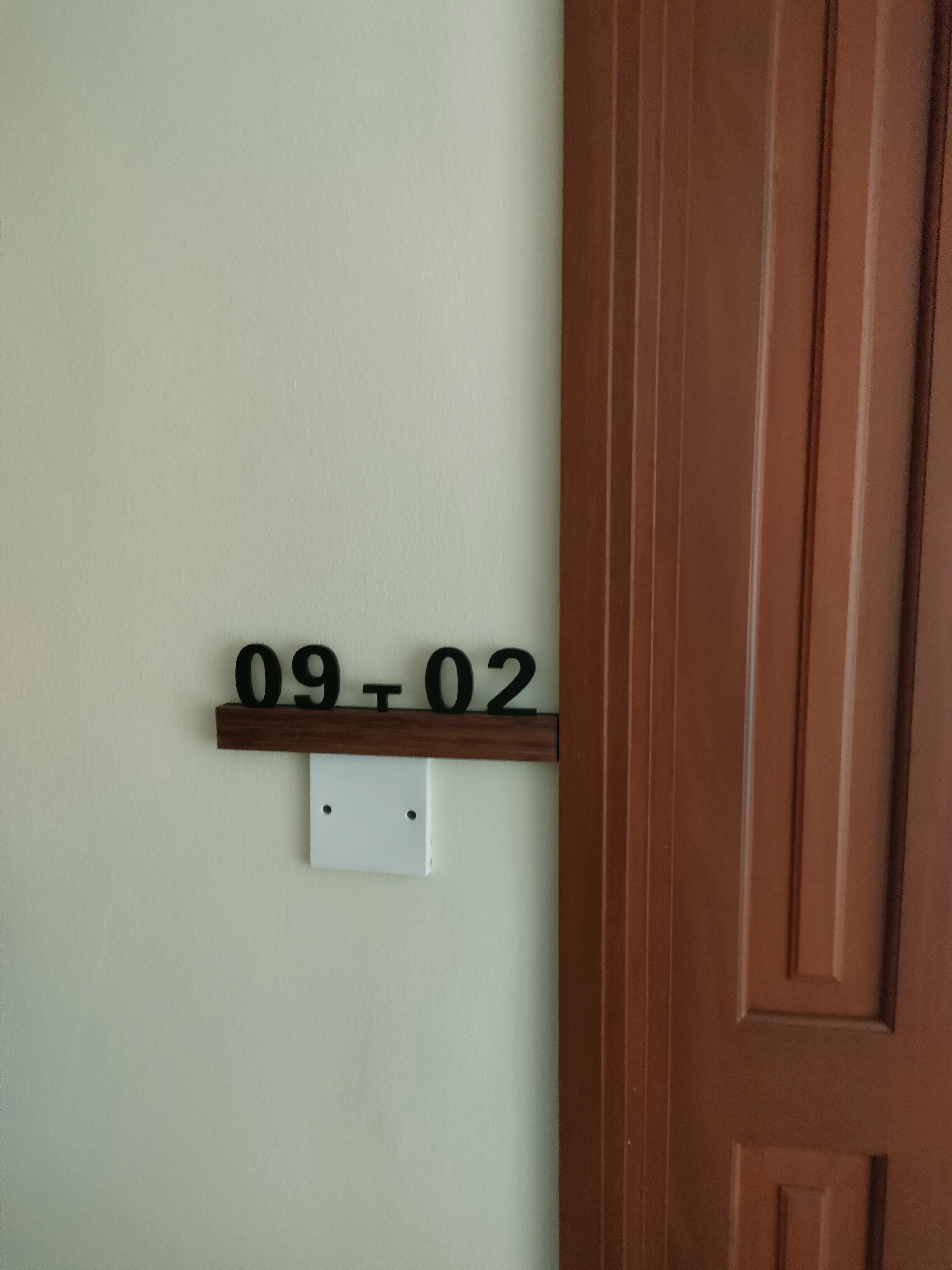 Our guests are greeted by this sight! - Wall-mounted number shelf, black numerals, 09 and 02, wooden shelf, white switch