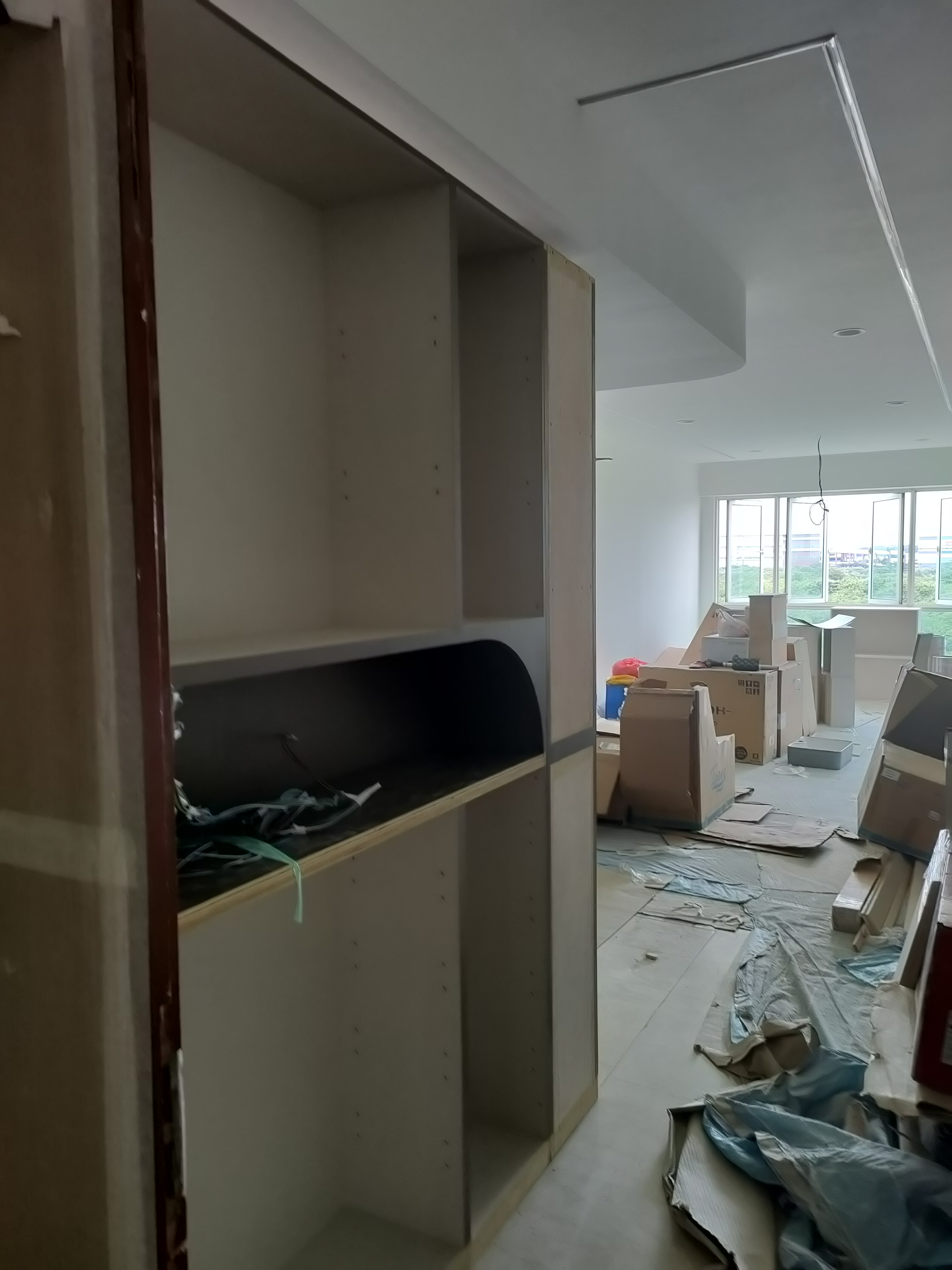 Our guests are greeted by this sight! - Interior space, unfinished room, construction site, wooden shelves, bare walls, large