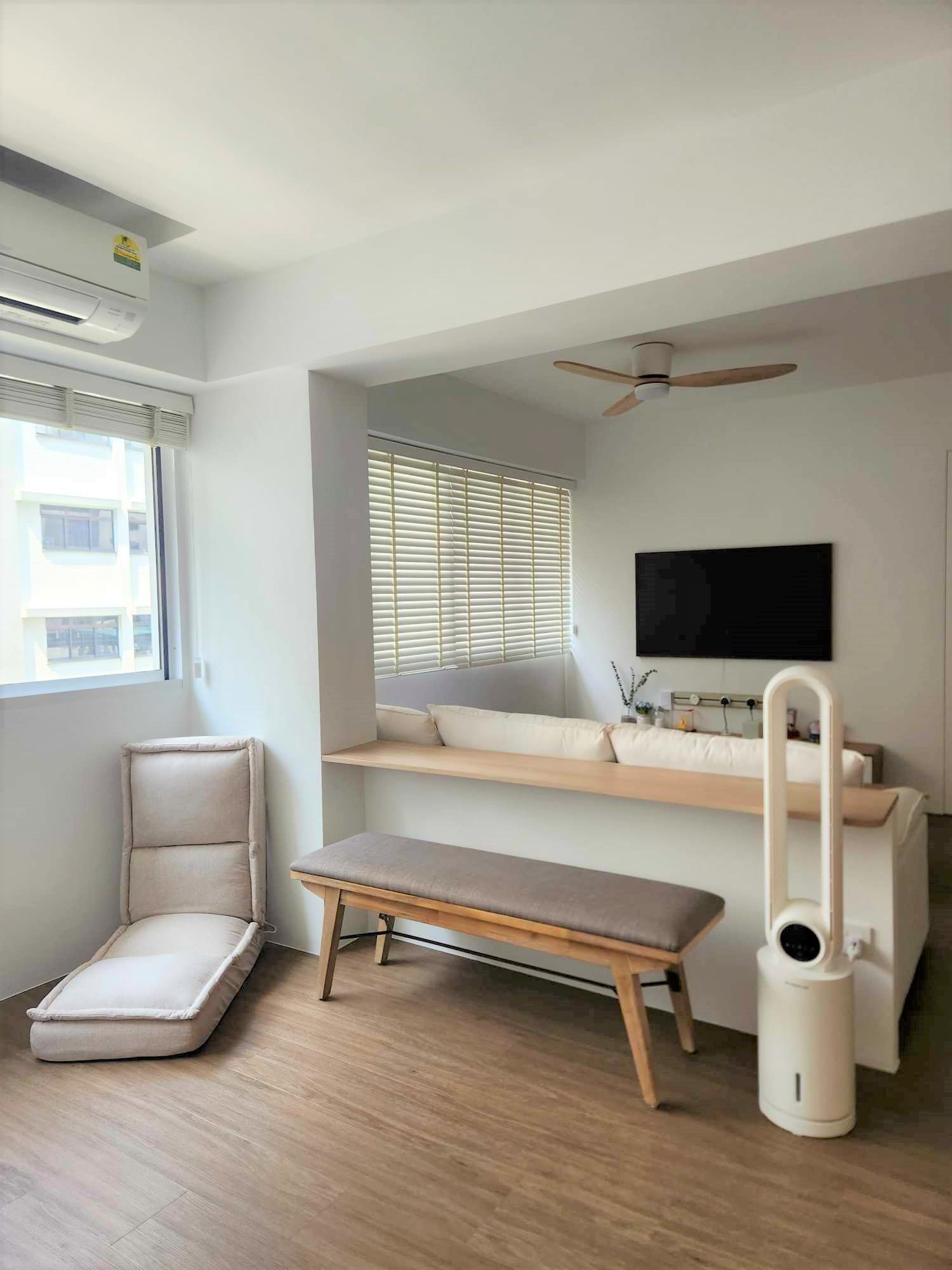 Subtle home workspace with no work from home schedule  - Modern minimalist living room with beige cushioned seating, sleek