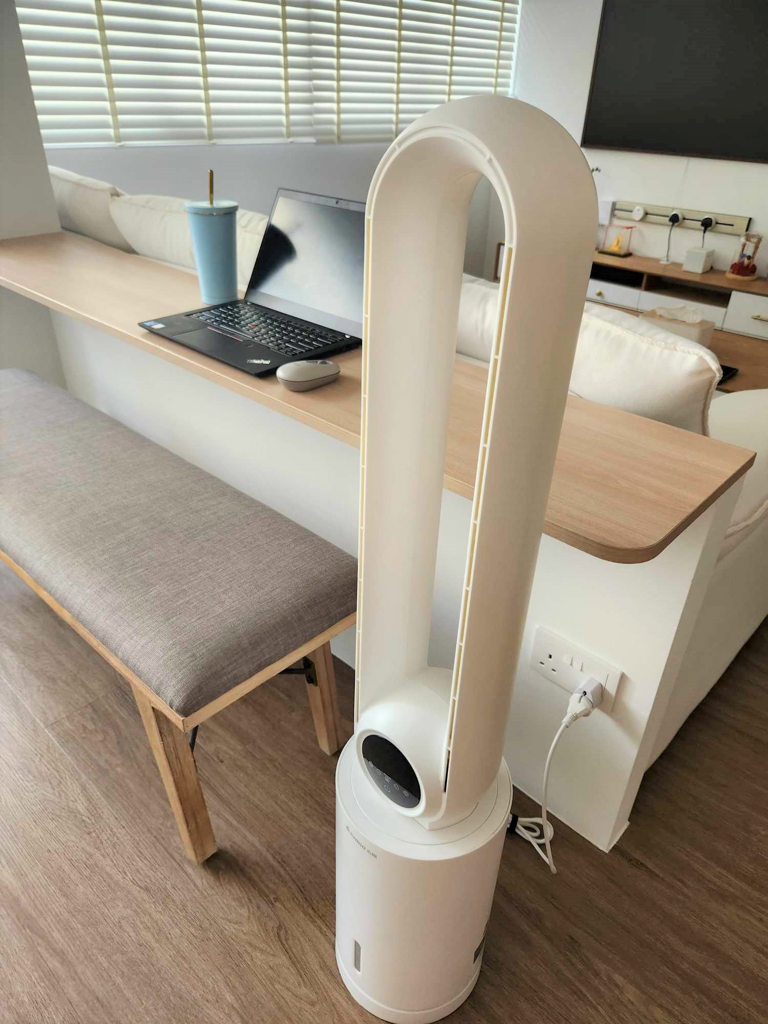 Subtle home workspace with no work from home schedule  - Laptop on wooden desk, blue cup on desk, ergonomic stool, modern