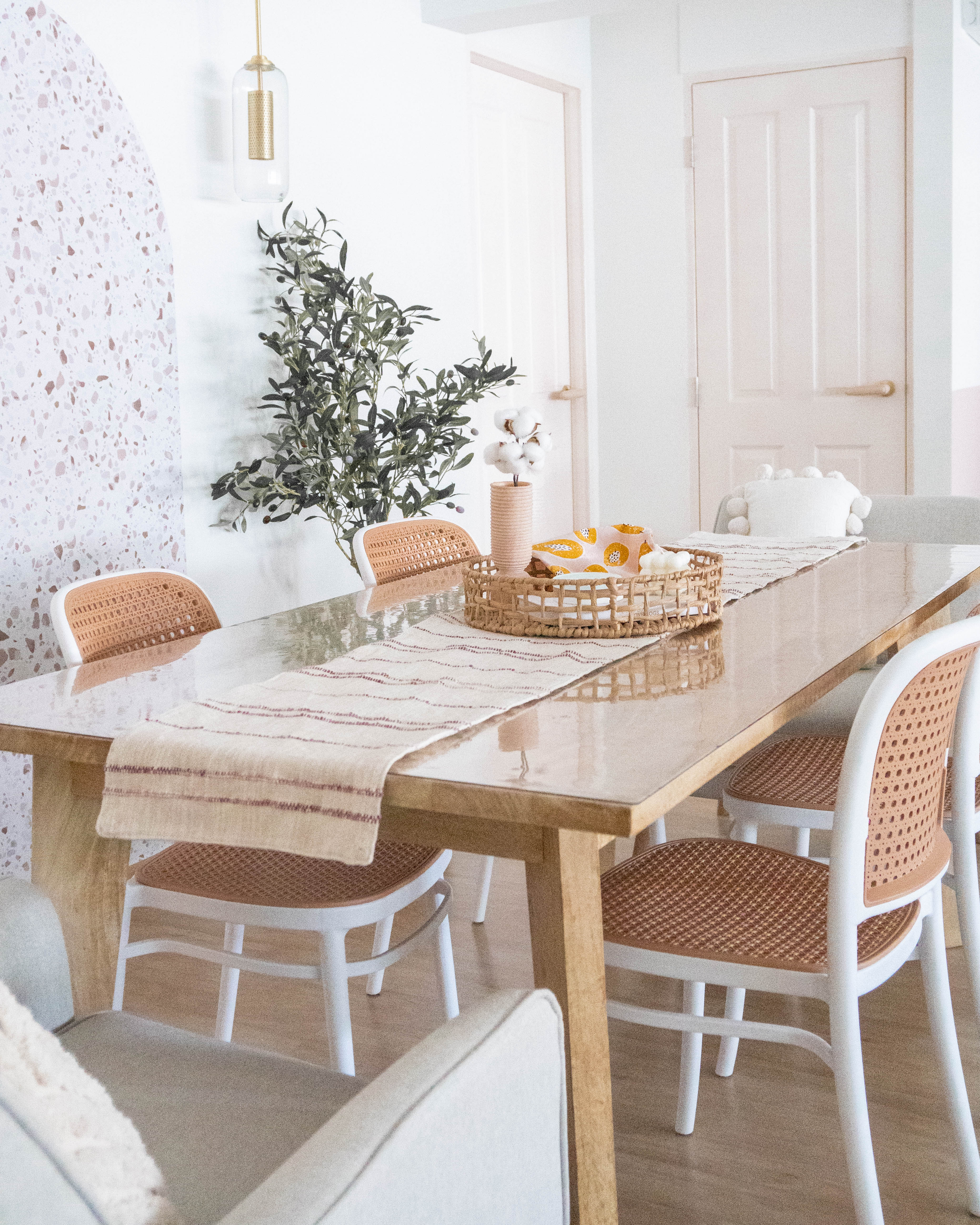 Modern Farmhouse Kitchen & Dining - White dining table with beige and brown woven chairs, wooden table surface, light beige