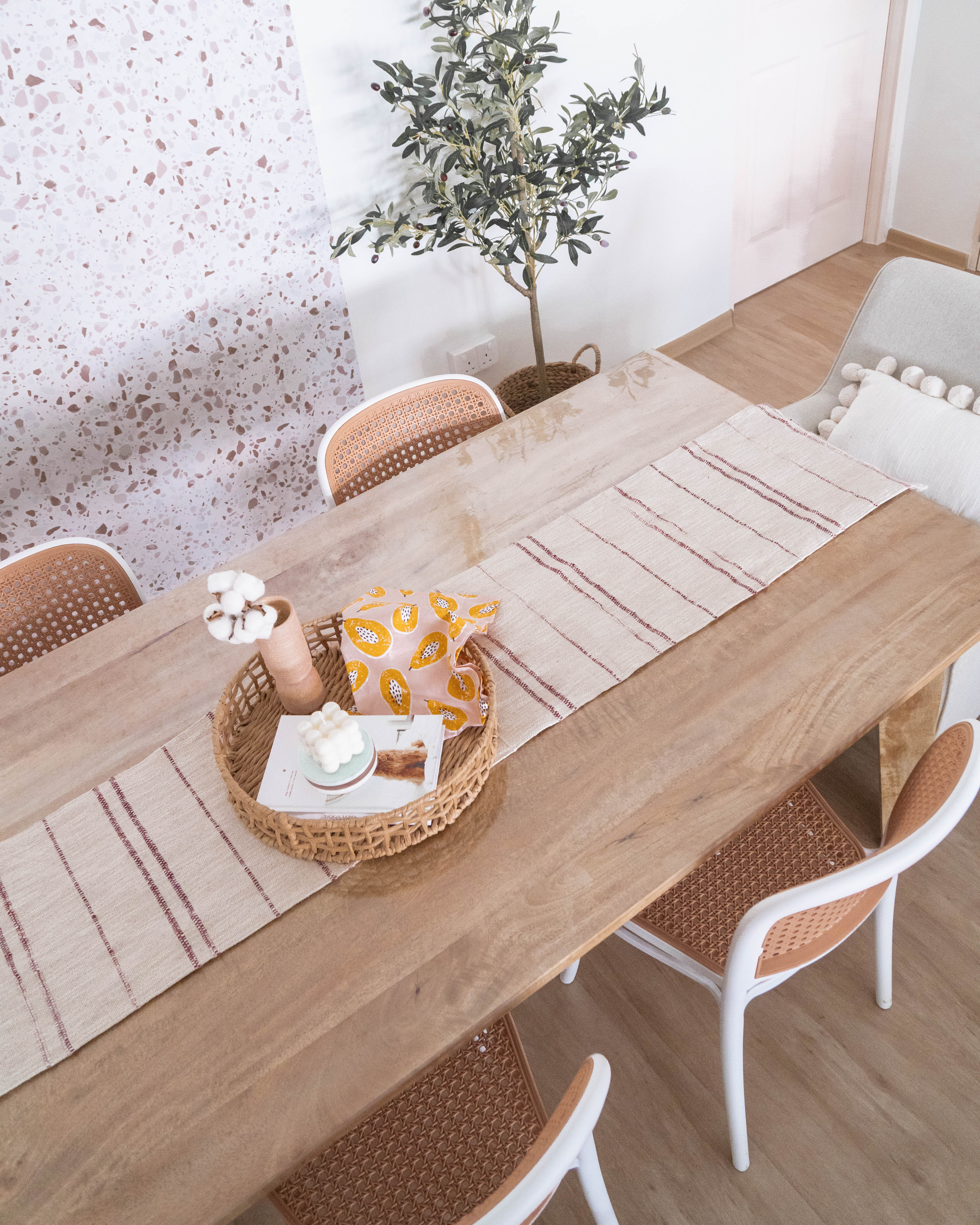 Modern Farmhouse Kitchen & Dining - Wooden dining table, beige and white striped placemats, woven basket, cotton balls