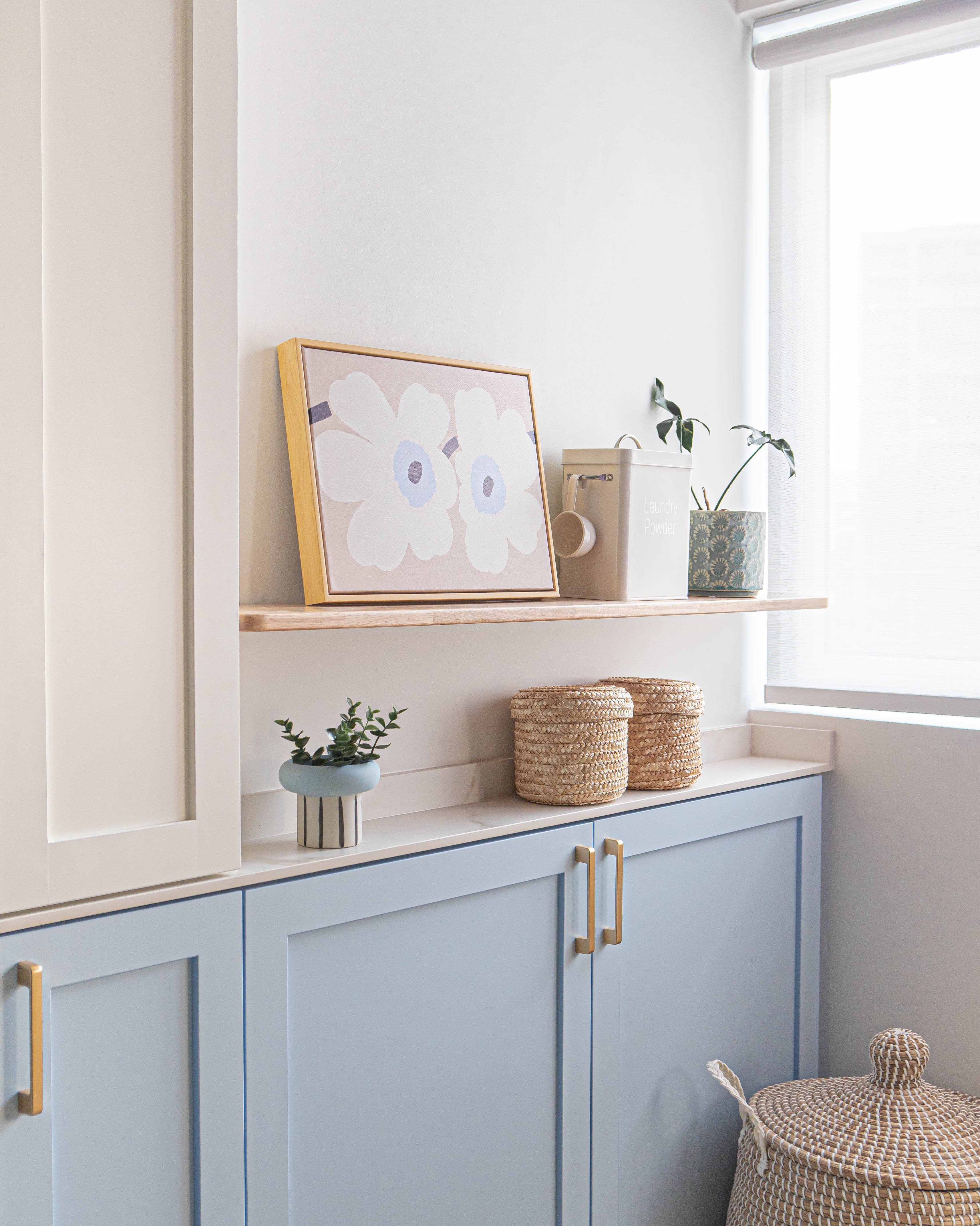 Modern Farmhouse Kitchen & Dining - White wall, minimalist decor, light blue cabinets, wooden shelf, abstract painting