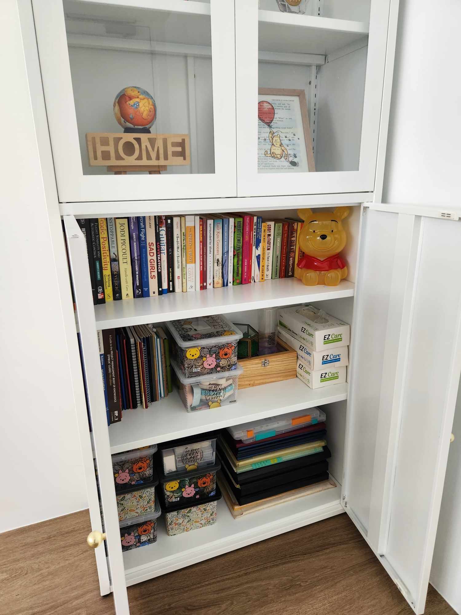 Guest room with inflatable bed for flexibility  - Bookshelf, white cabinet, open shelf, colorful books, decorative globe