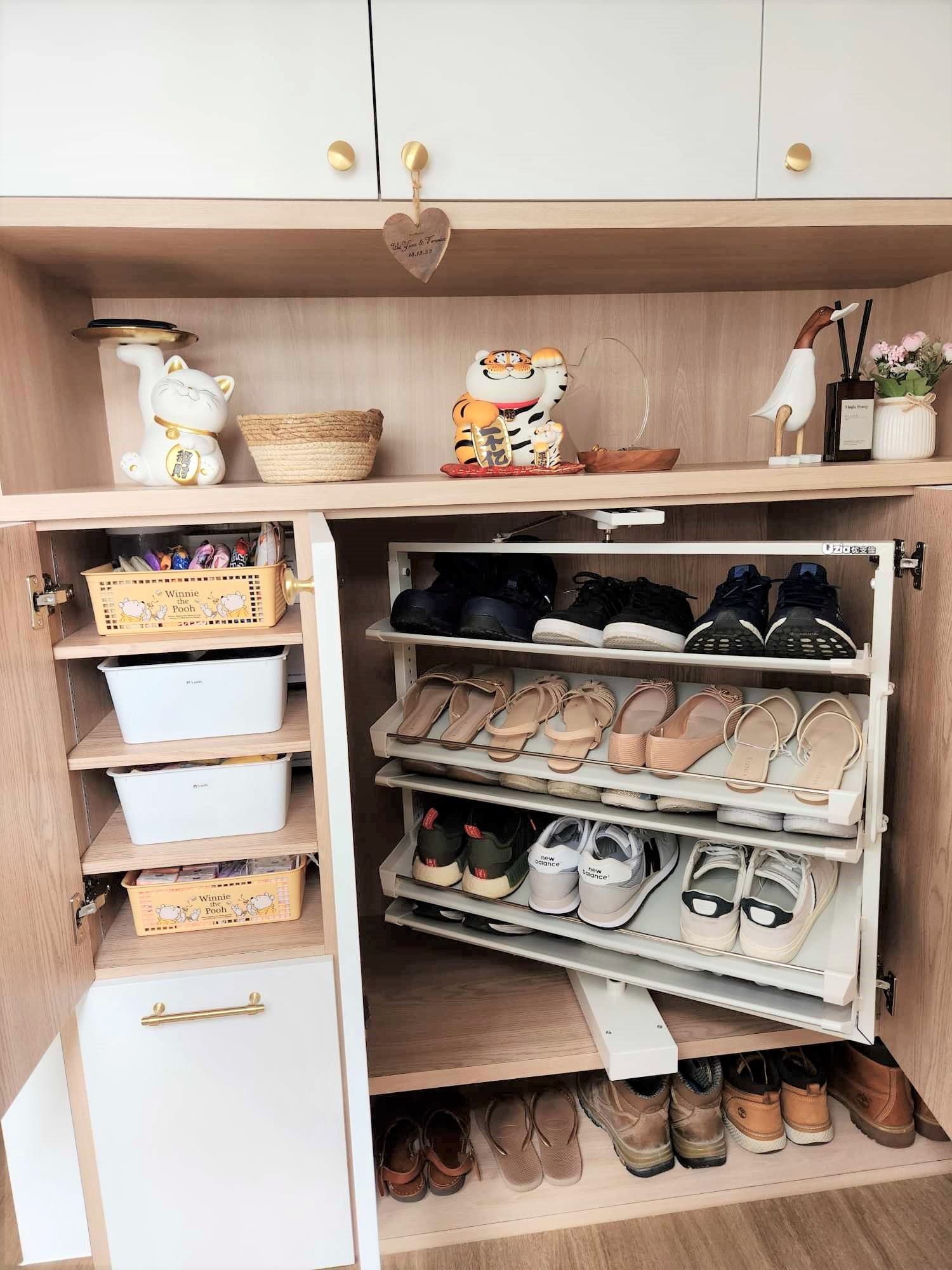 Hidden settee in our entry way  - Wooden cabinet with open doors, neatly organized shoes, white storage bins, decorative cat