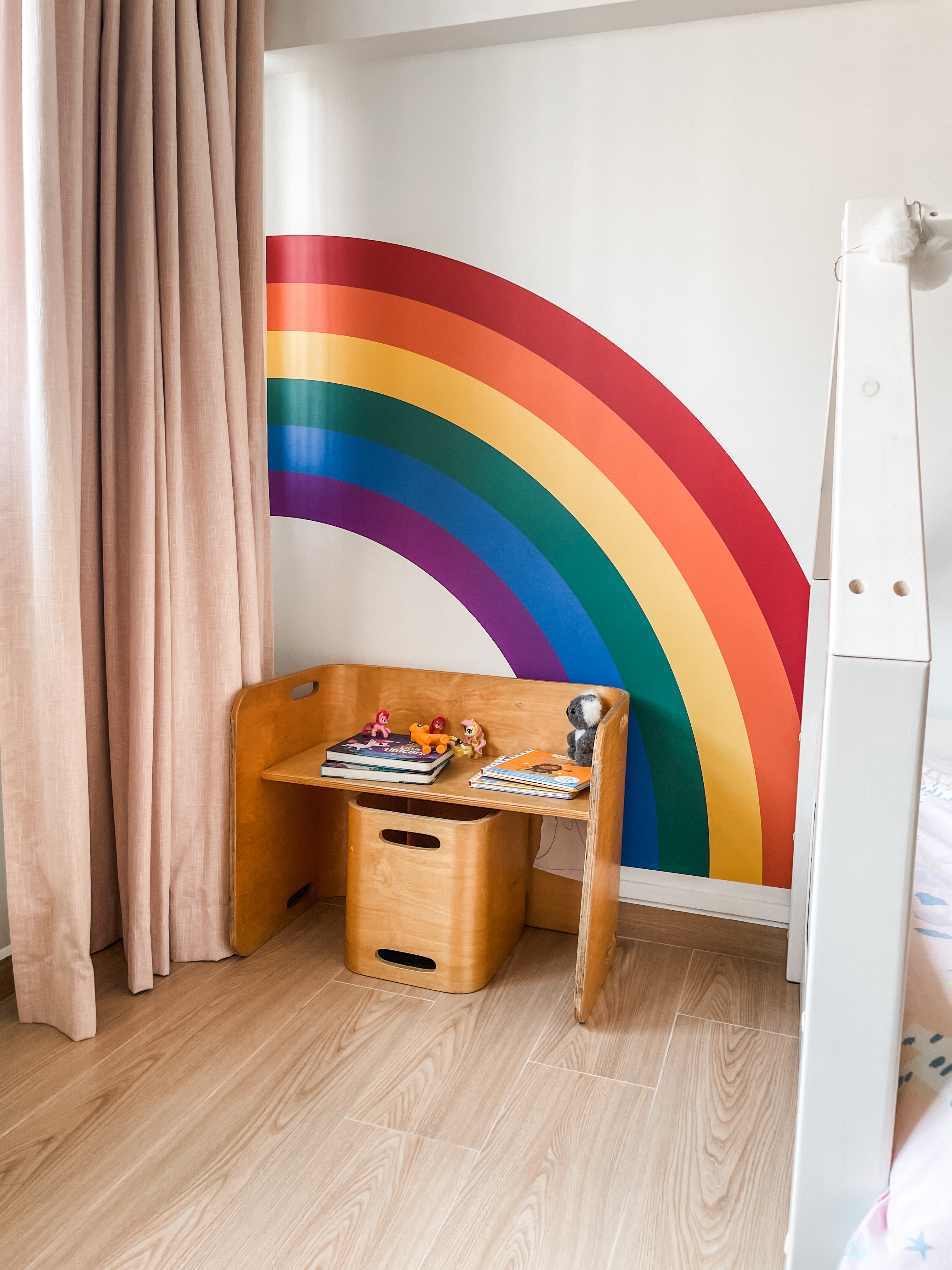 Kids' Rooms: Over The Rainbow And Into The Woodland - Soft beige curtains, wooden desk, colorful rainbow wall art, wooden