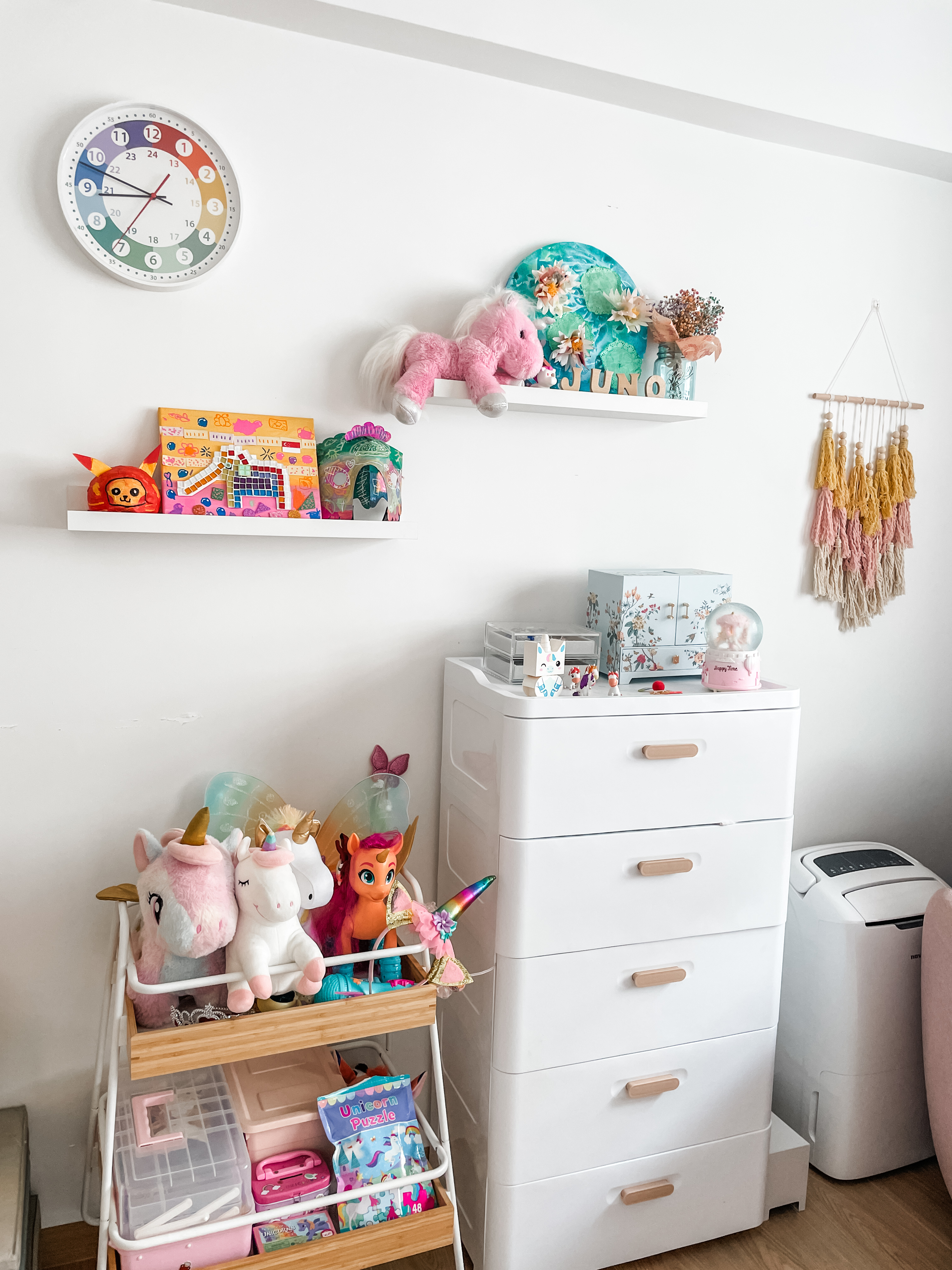 Kids' Rooms: Over The Rainbow And Into The Woodland - Colorful unicorn plush toys, pastel-colored wall clock, whimsical