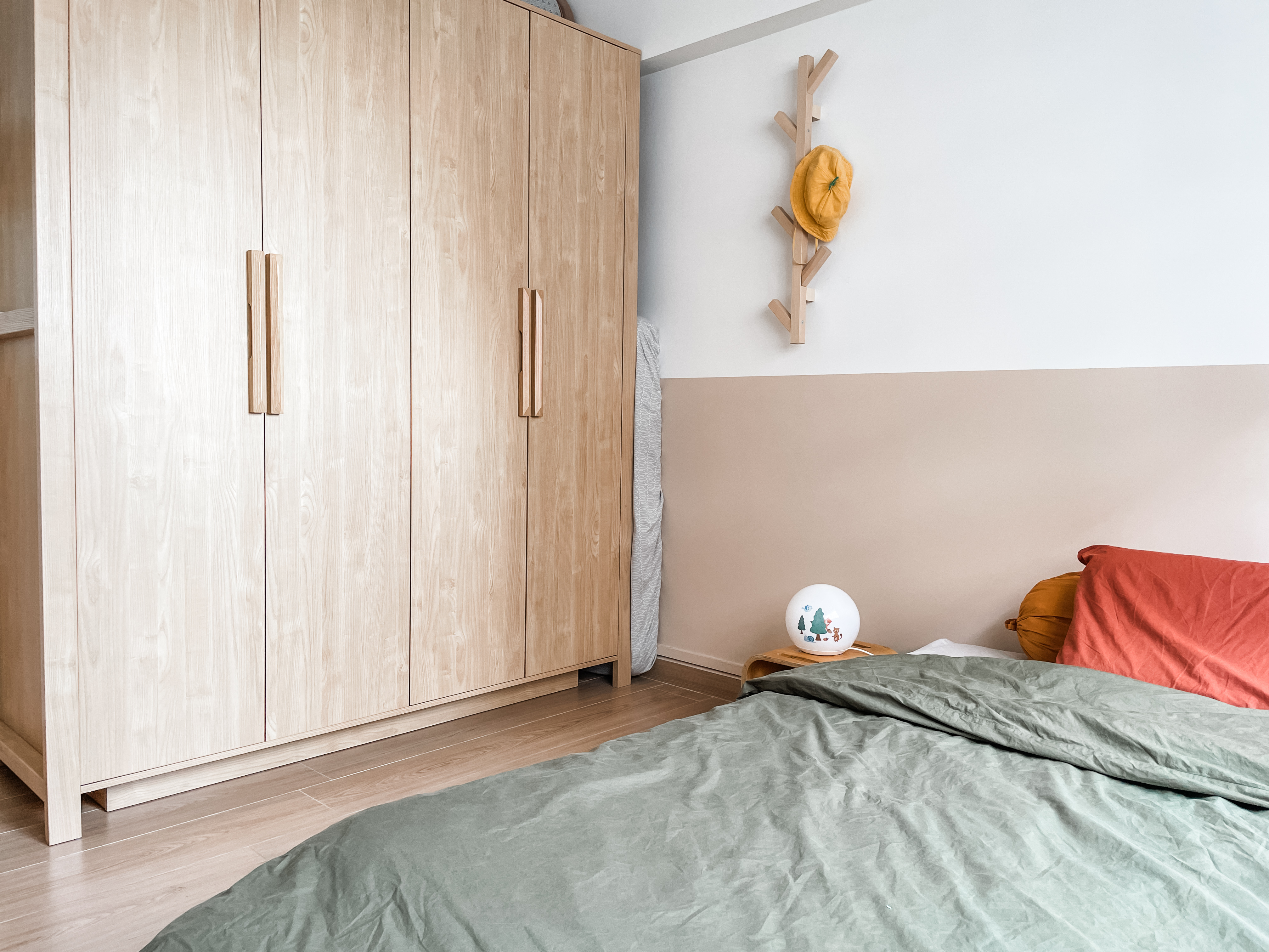 Kids' Rooms: Over The Rainbow And Into The Woodland - Wooden wardrobe, beige wall, wooden shelf, yellow hat, wooden clothes