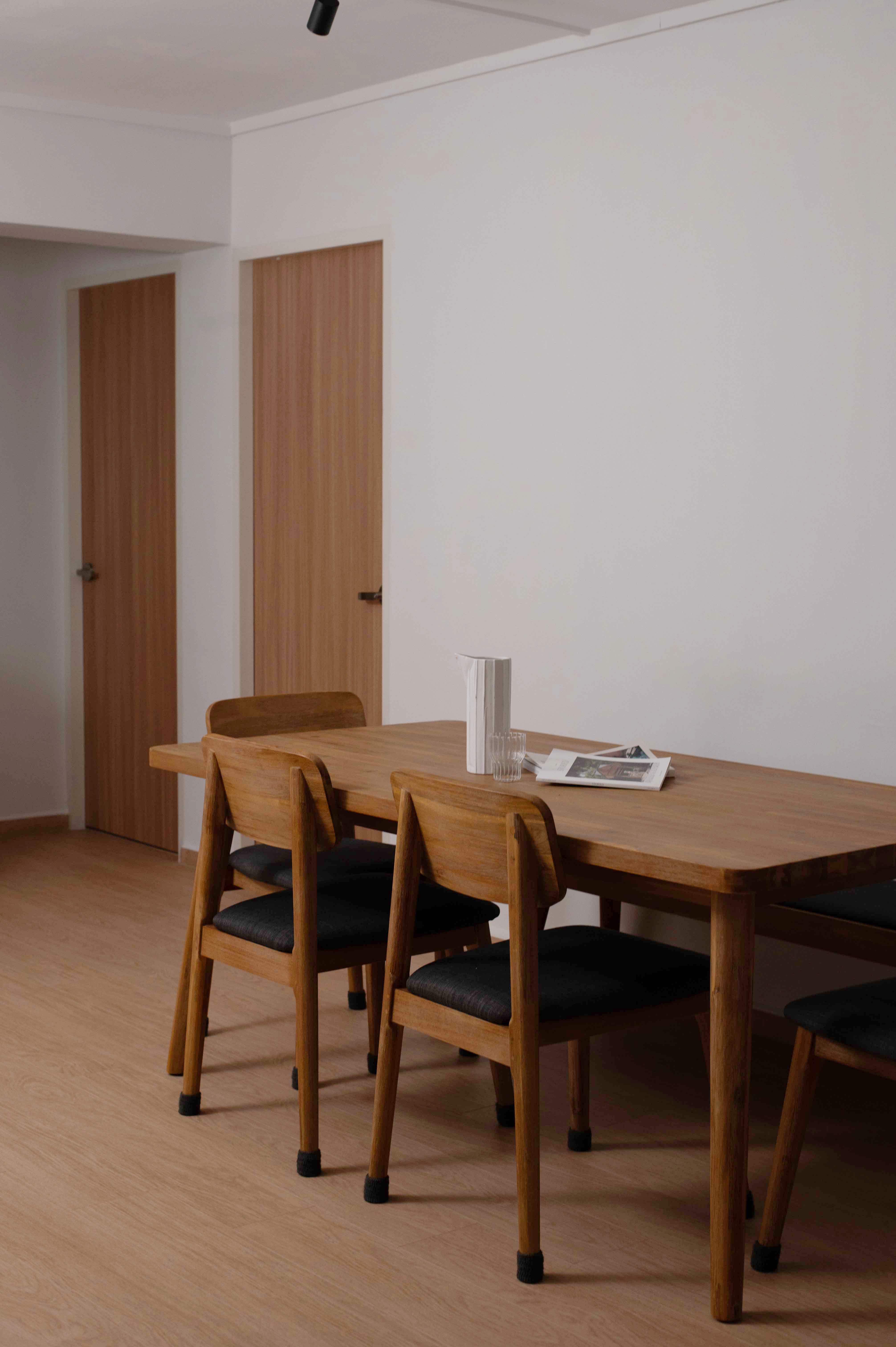 Exploring Blue Tones in a Scandinavian Home - Wooden dining table, minimalist design, modern furniture, wooden chairs, black