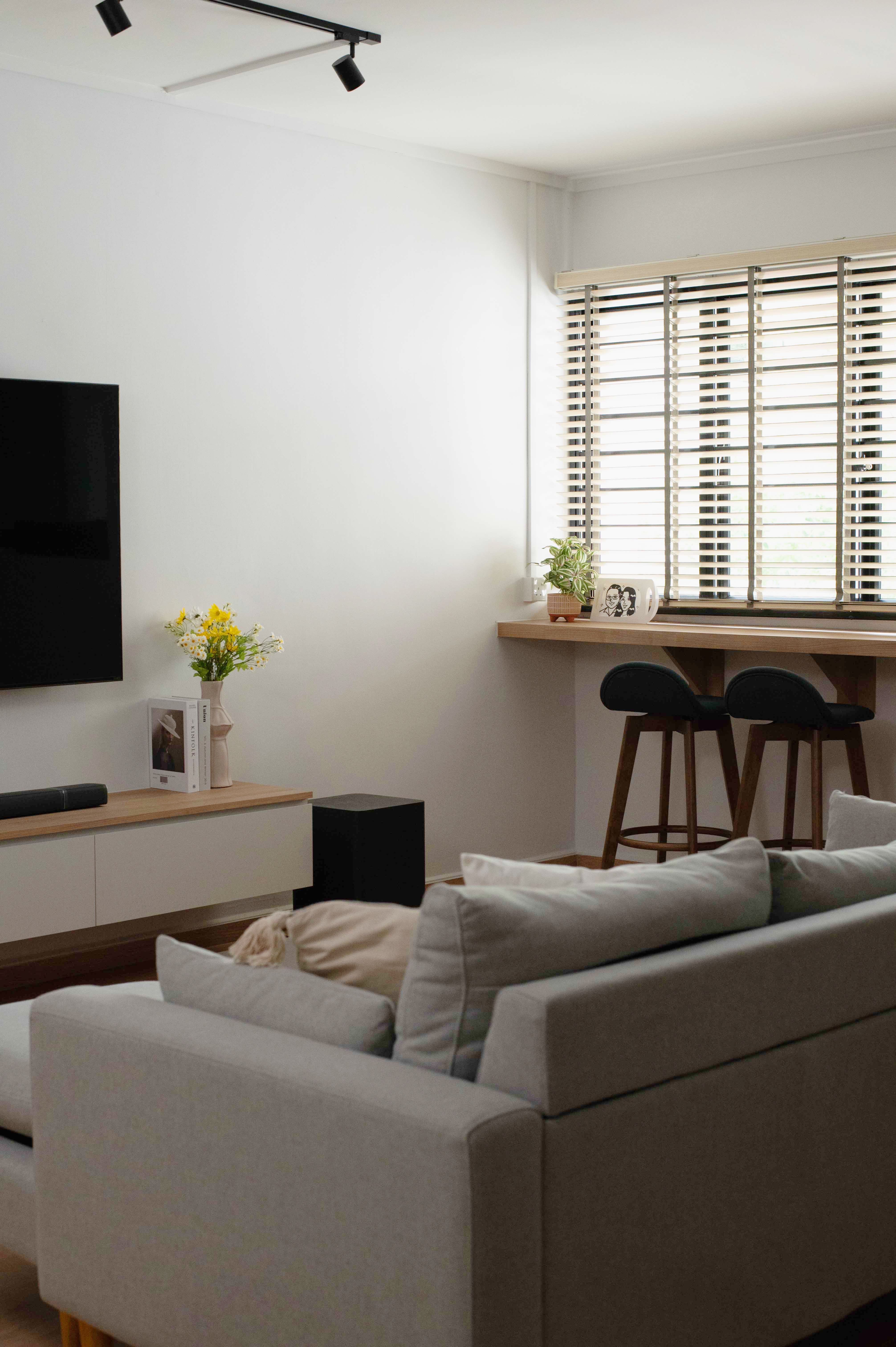 Exploring Blue Tones in a Scandinavian Home - Modern living room, minimalist decor, white walls, large window, black TV