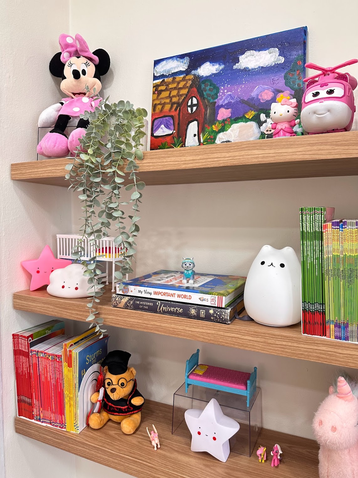A Super Mario wonderland  - Mickey plush toy, pink polka dot dress, green leafy plant, wooden shelf, colorful painting, Hello