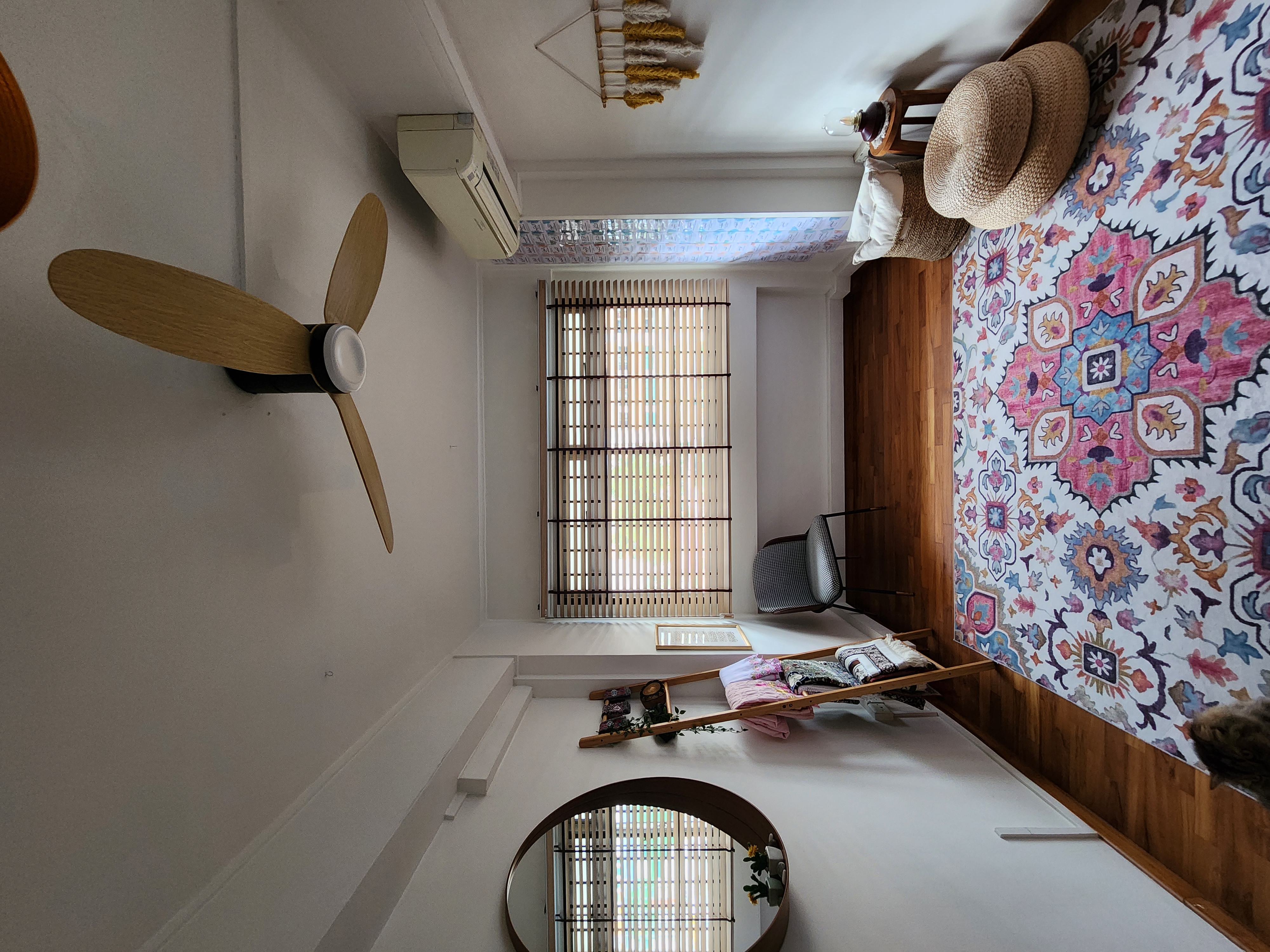 Chillax multi-purpose room - ceiling fan, window, wooden blinds, air conditioning unit, rattan hat, colorful tapestry, wooden