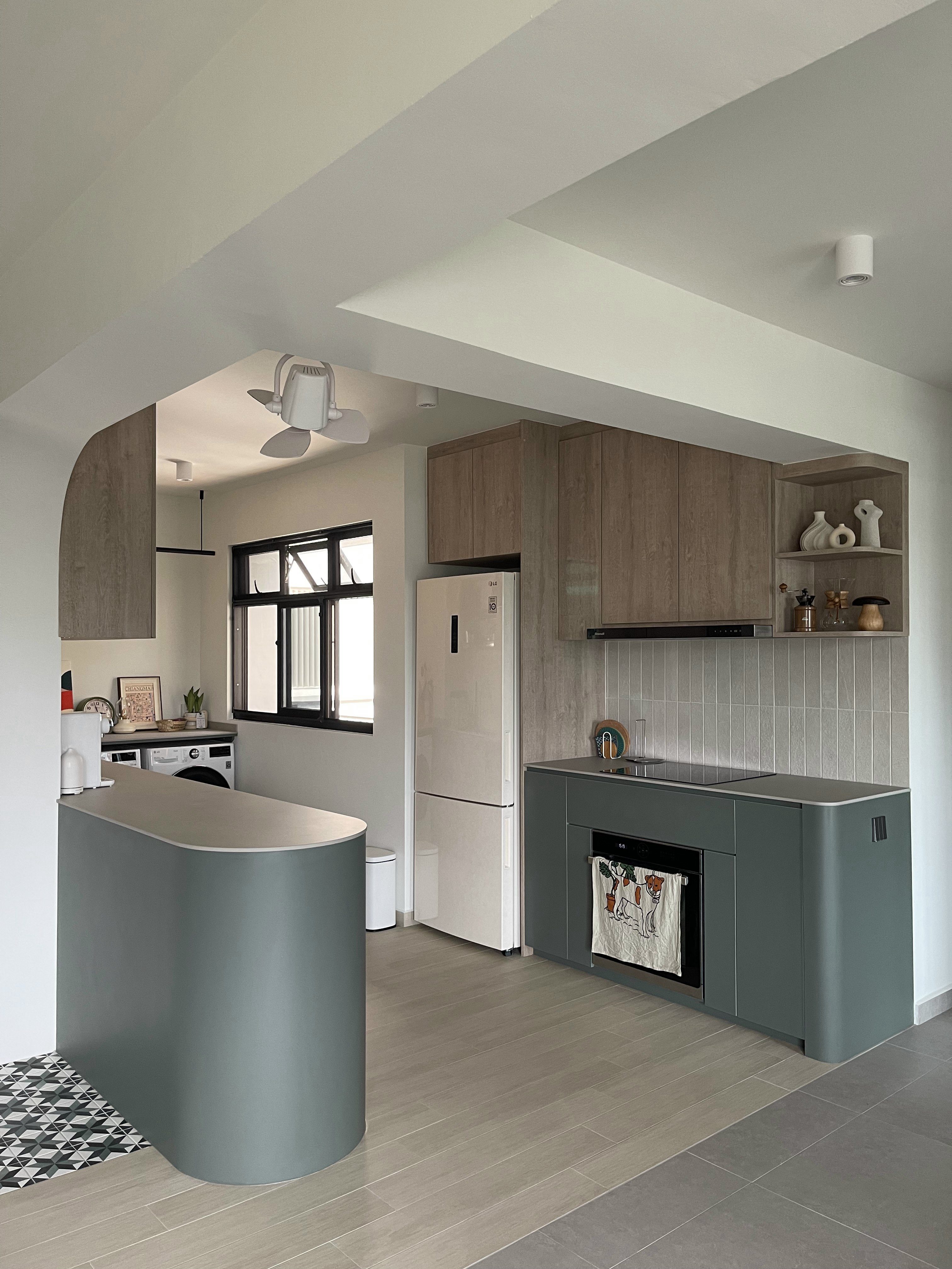 An Open-concept Galley Kitchen + Service Yard - Modern kitchen with sleek design, light wood cabinets, white refrigerator