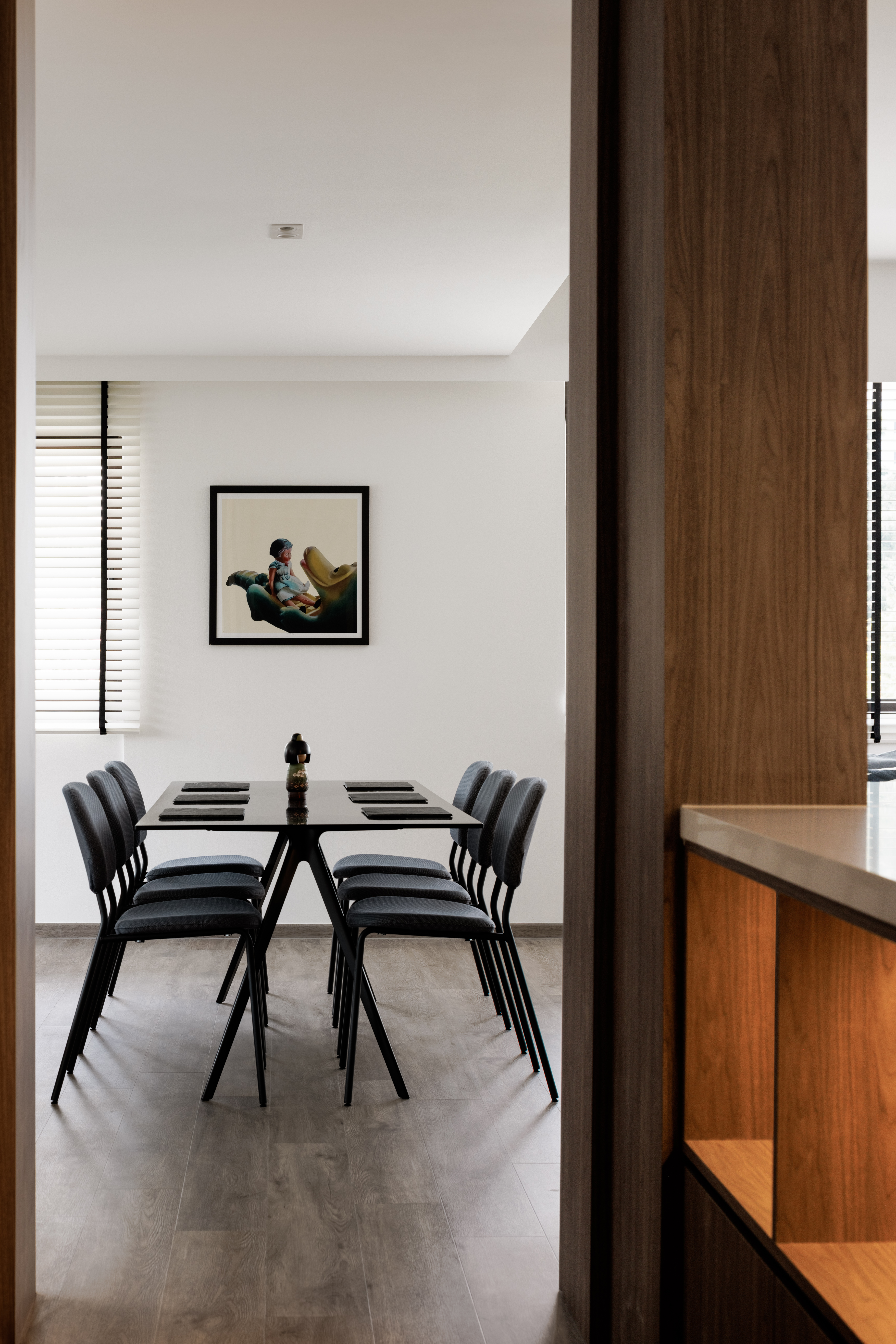 A Bright and Elegant Open Plan Home - Modern dining room with sleek black chairs, minimalist design, wooden accents, large