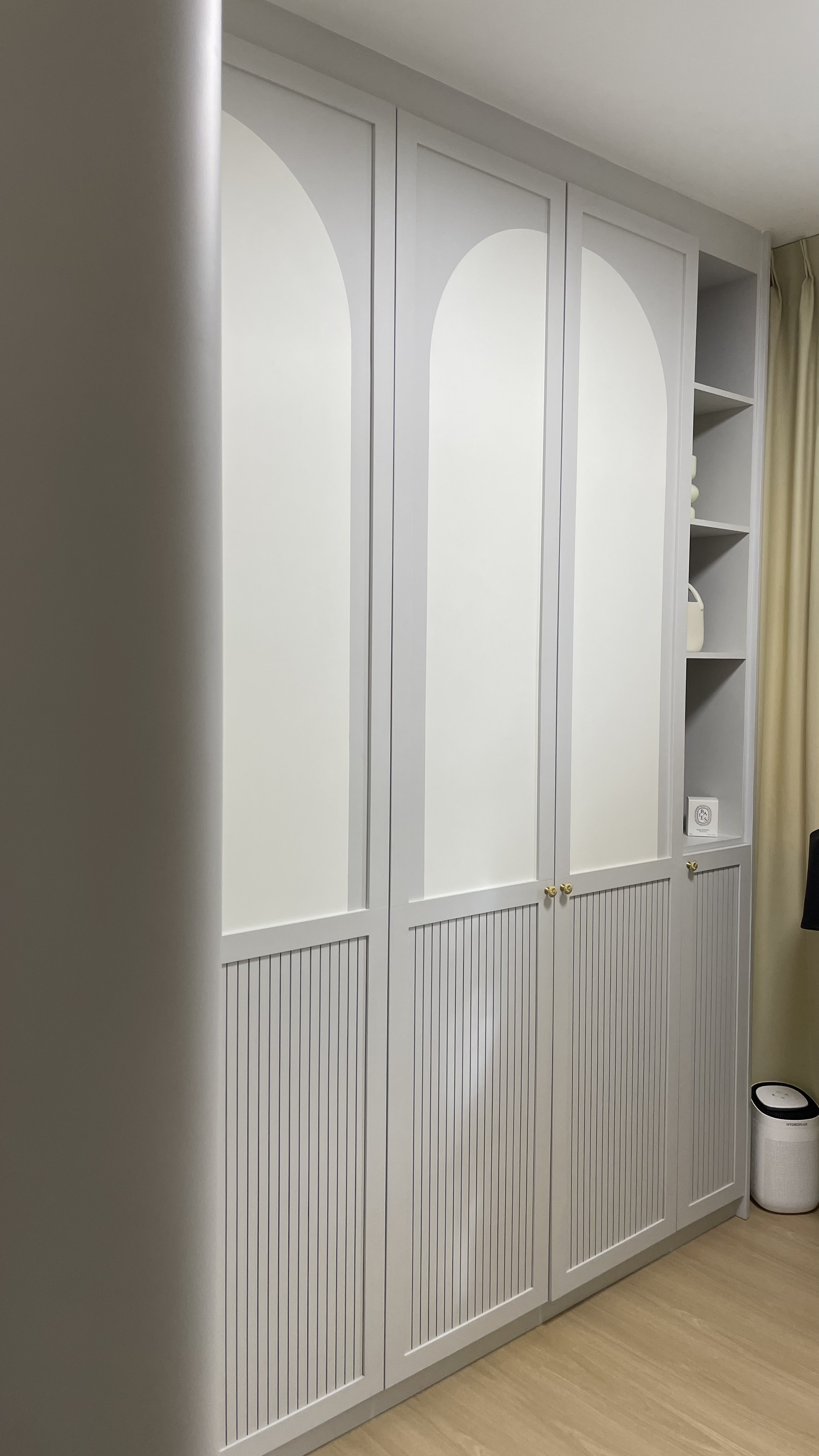 Juzz up your home with affordable aesthetic decor pieces - White paneled wardrobe with arched doorways, minimalist design