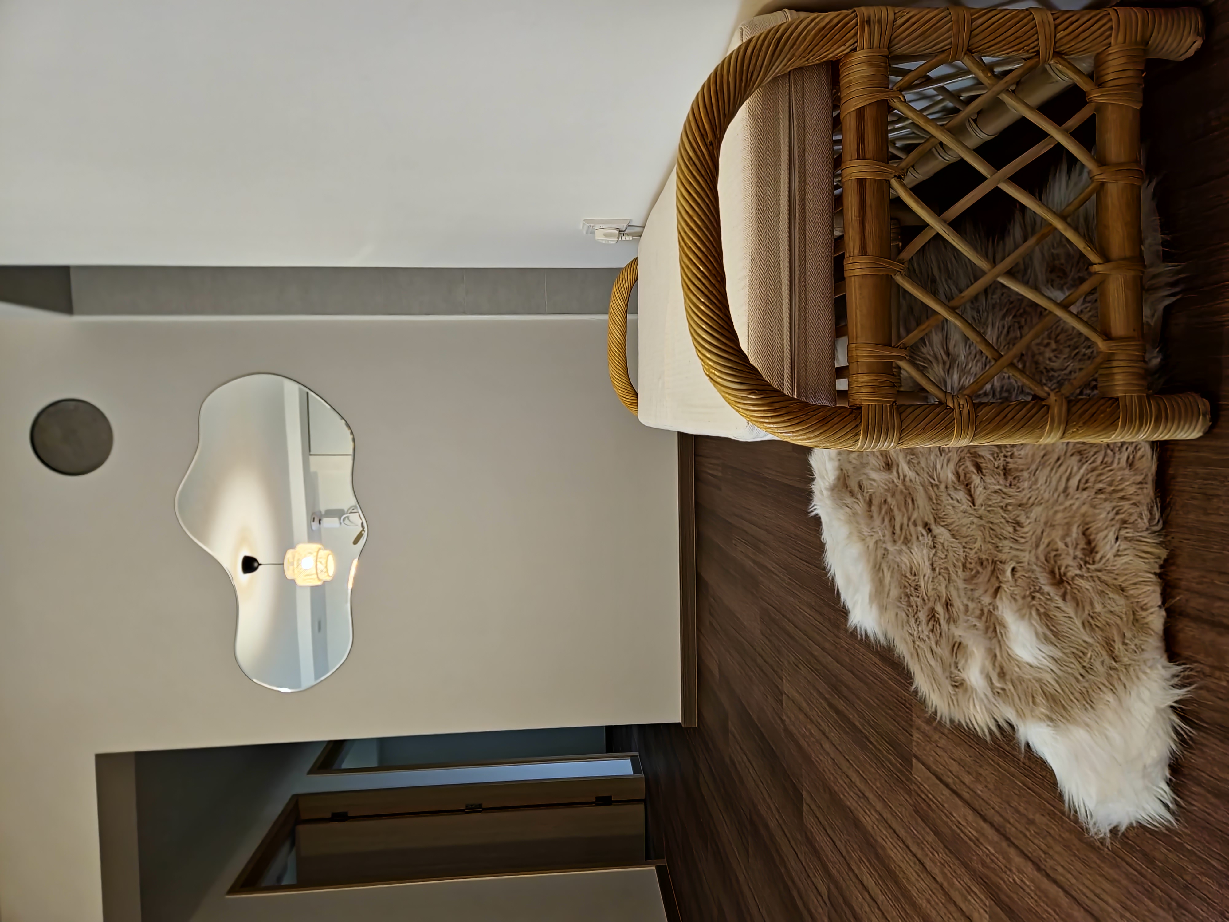 A modern and minimalist living room with scandinavian charm - Woven bamboo furniture, modern interior design, textured rug