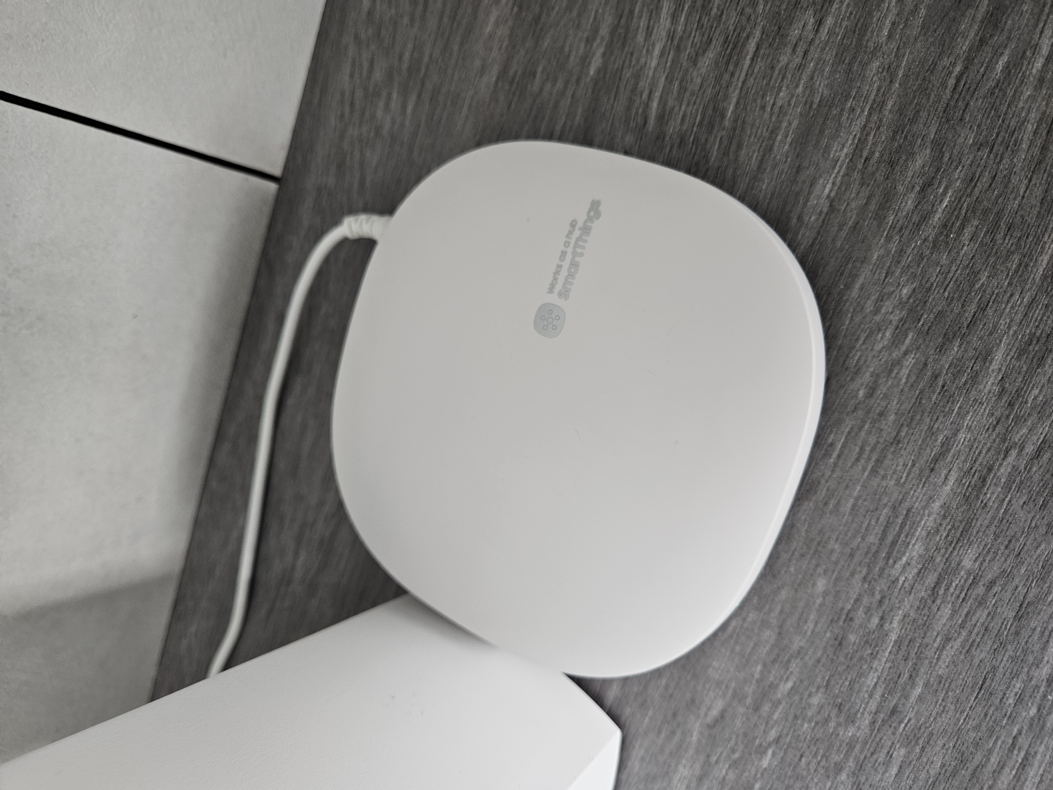 Integrating Smart Devices In Our Home - Sleek, modern wireless router, White, circular design, Wireless connectivity device