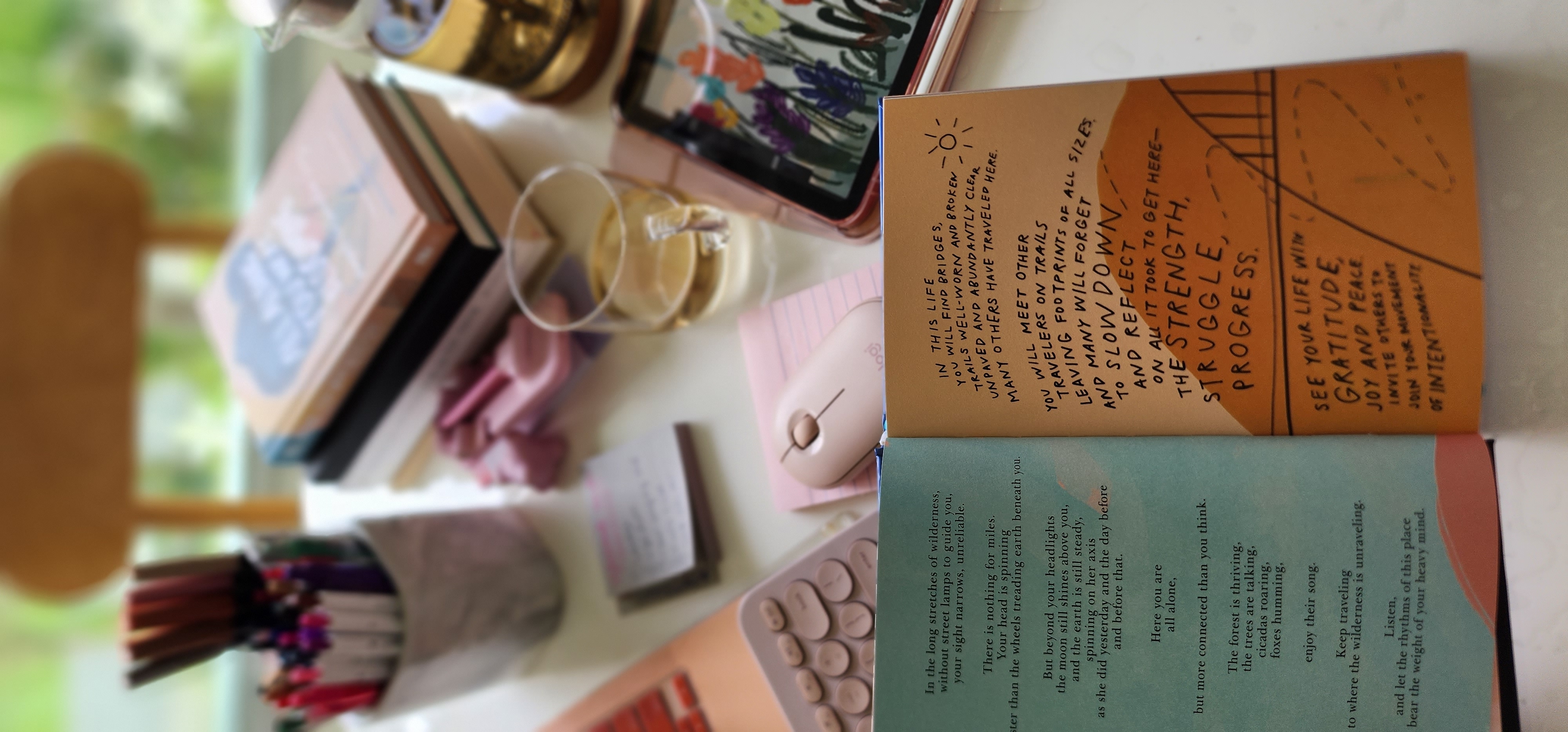 Enjoy your home, you deserve it! - Cozy workspace with a smartphone and notebooks, Open book with motivational quotes and