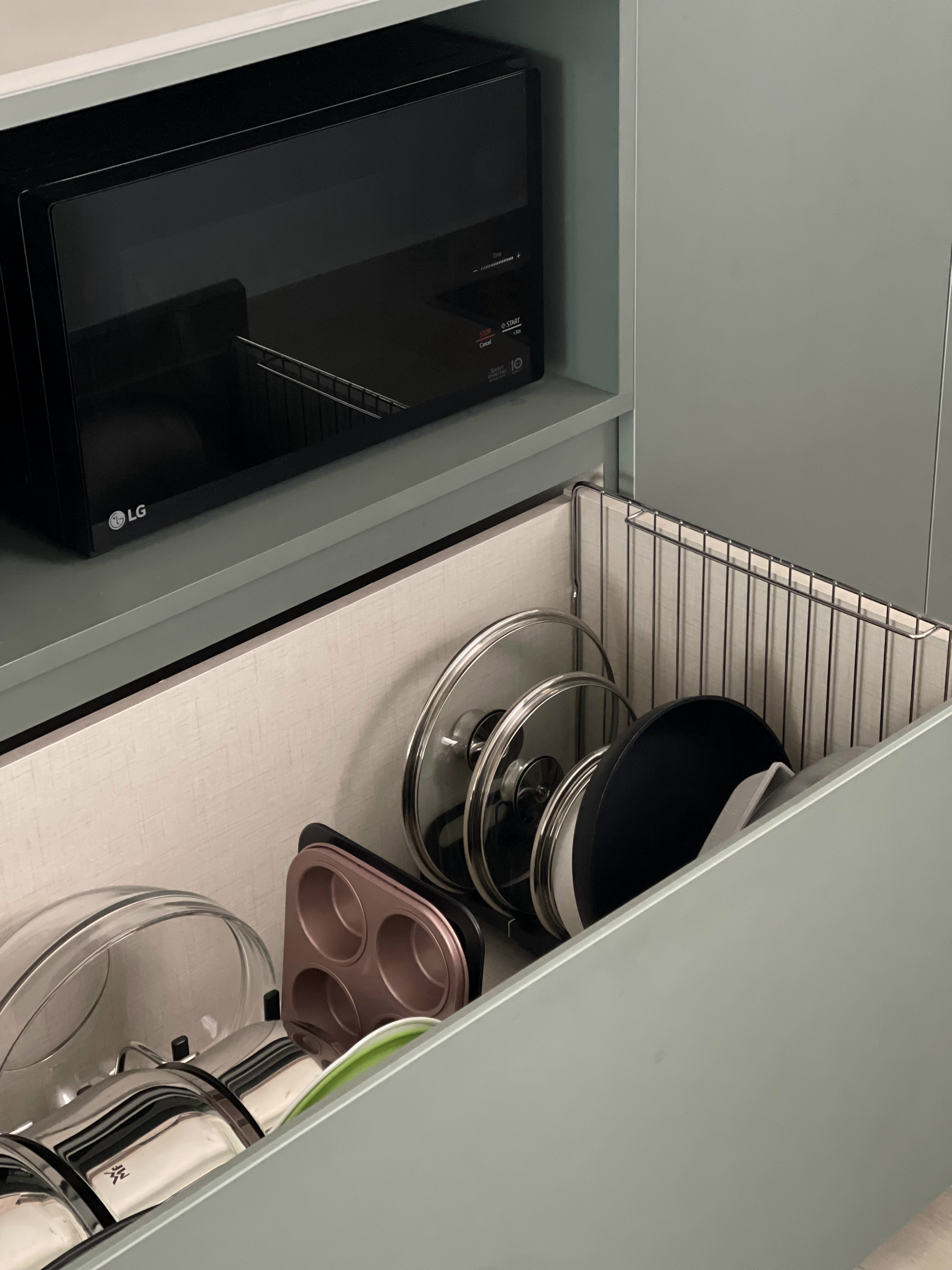 An Open-concept Galley Kitchen + Service Yard - microwave, kitchen, dish rack, stainless steel, glass bowls, black and