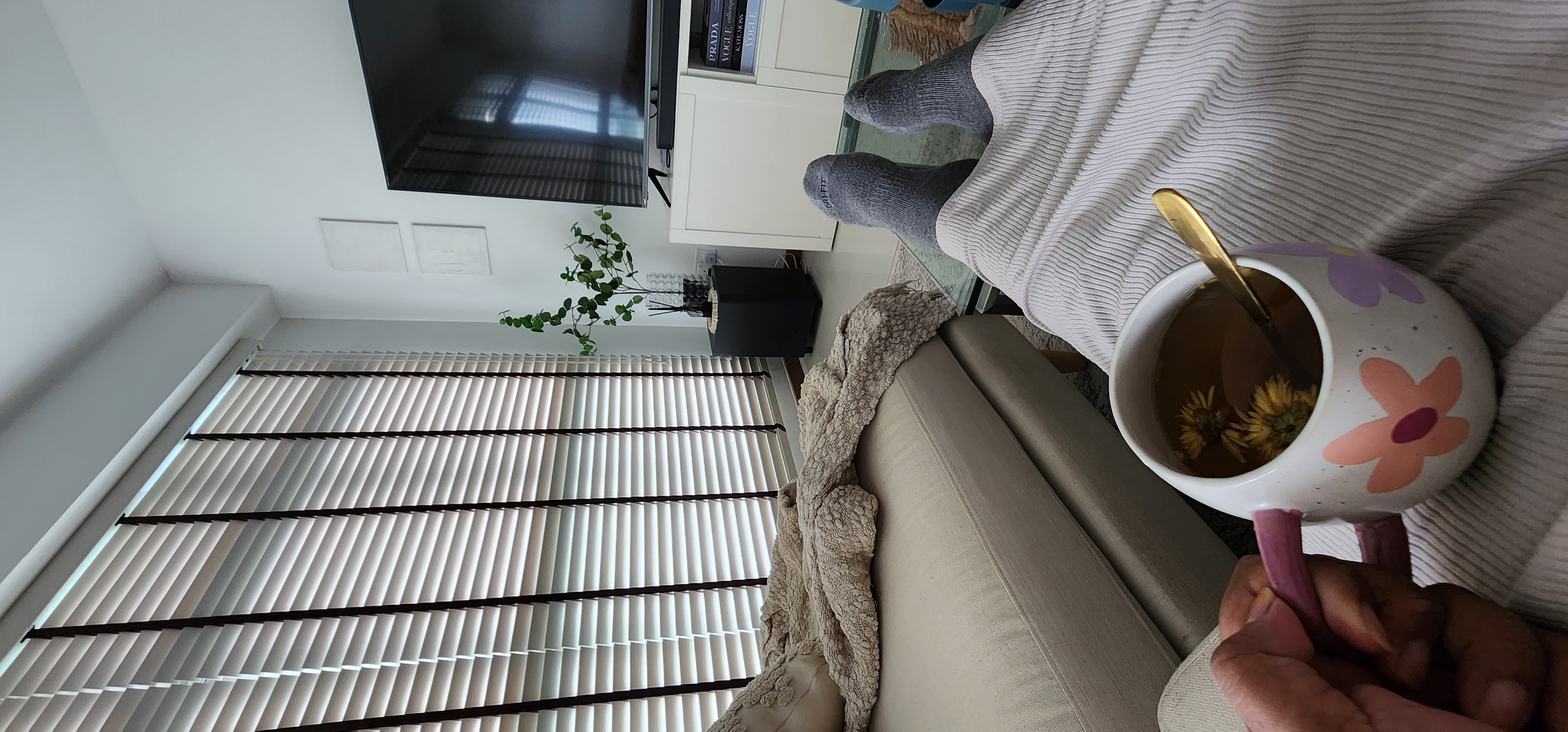 Enjoy your home, you deserve it! - gray socks, white blanket, indoor setting, cozy atmosphere, cup with tea, floral design